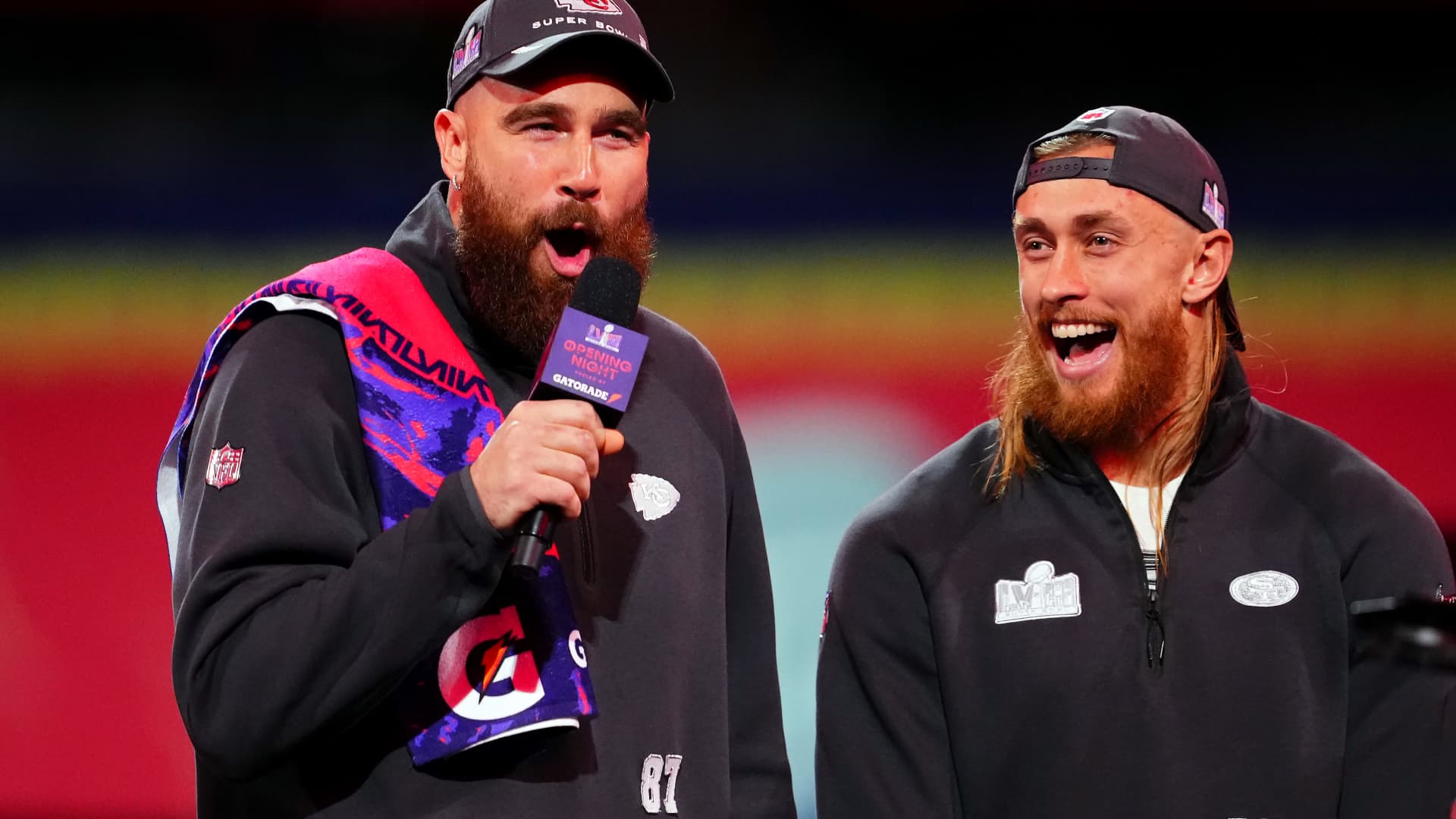 Travis Kelce of the Kansas City Chiefs, left, and George Kittle of the San Francisco 49ers stand on stage during the NFL's Super Bowl Opening Night show at Allegiant Stadium in Las Vegas, Feb. 5, 2024.
