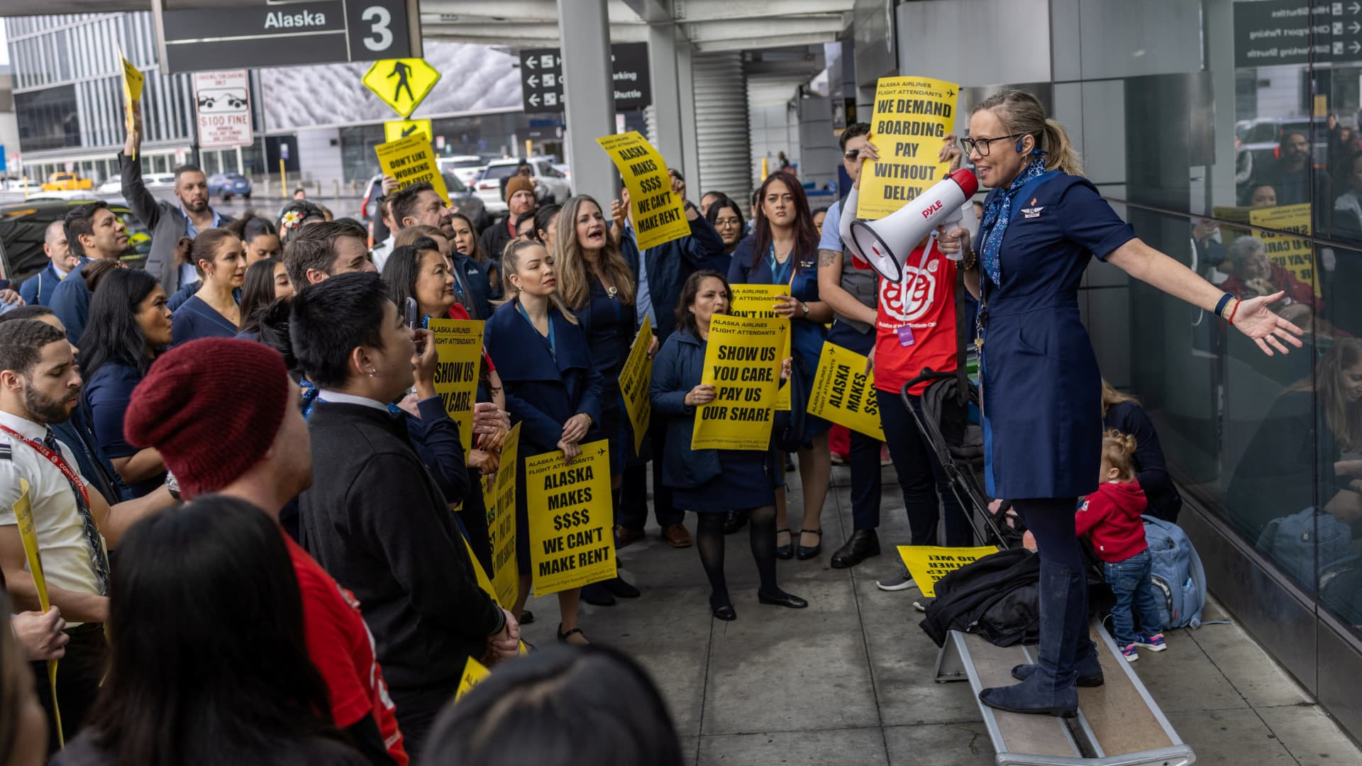 Alaska Airlines flight attendants gather at a picket line protesting for landmark changes in their new contracts, currently under negotiation, at San Francisco International Airport, in San Francisco, California, U.S. December 19, 2023.