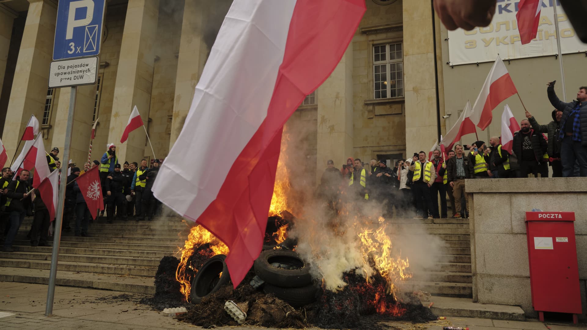 A fire burns outside the Provincial Office of Lower Silesia during a protest by Polish farmers in Wroclaw, Poland, on Thursday, Feb. 15, 2024.