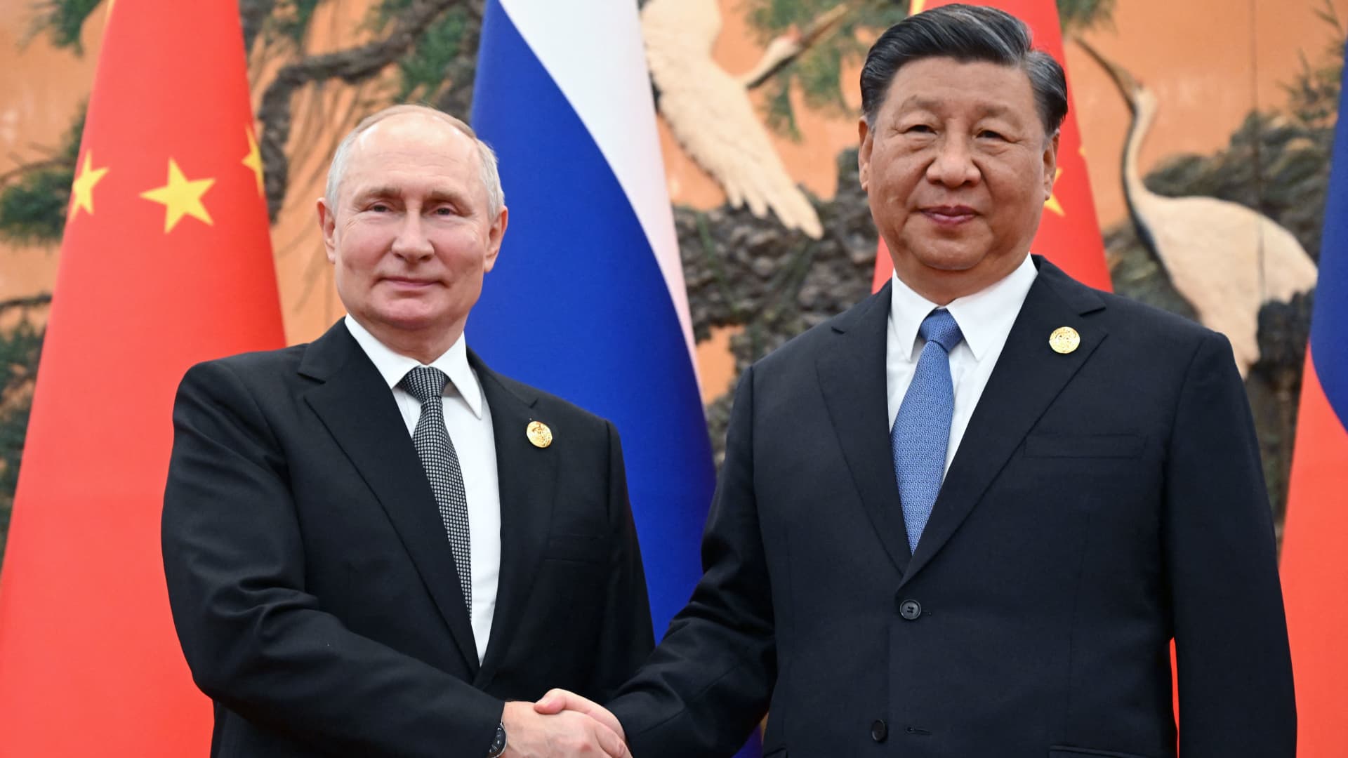 Russia's President Vladimir Putin and Chinese President Xi Jinping shake hands during a meeting in Beijing on October 18, 2023.