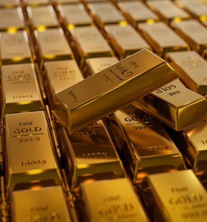 Gold edges down as U.S. dollar firms