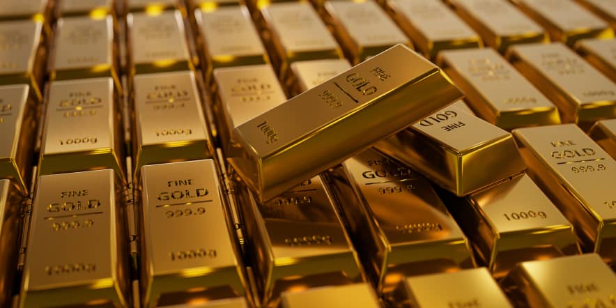Gold slips as dollar firms, traders brood on rate cut timing