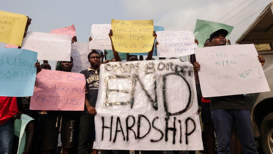 Demonstrators hold placards during a protest against the hike in price and hard living conditions in Ibadan on February 19, 2024. (Photo by SAMUEL ALABI / AFP) (Photo by SAMUEL ALABI/AFP via Getty Images)