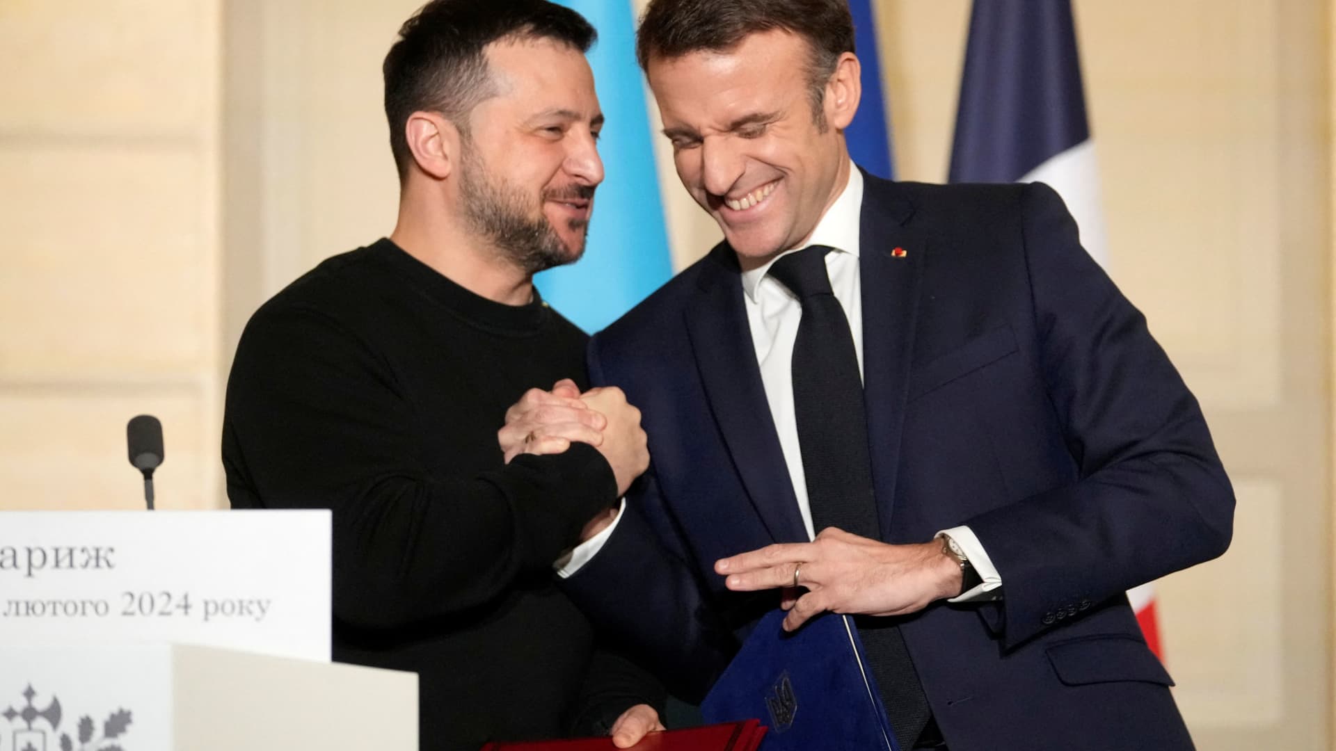 French President Emmanuel Macron and his Ukrainian counterpart Volodymyr Zelenskyy react after signing an agreement, February 16, 2024 at the Elysee Palace in Paris, France. 