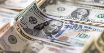 Dollar inches down as heavy week of data begins