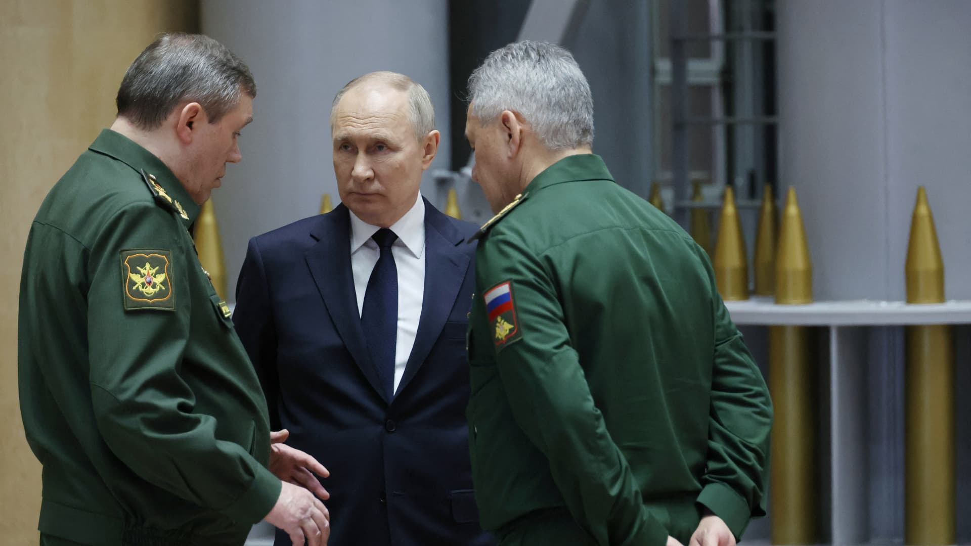 Russian President Vladimir Putin and Defence Minister Sergei Shoigu tour a military gear exhibition after an expanded meeting of the Russian Defence Ministry Board at the National Defence Control Centre in Moscow on December 19, 2023.
