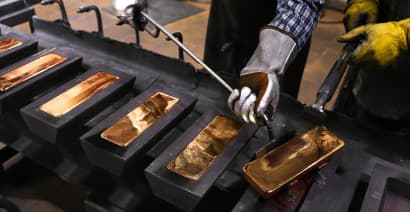 Gold gains on dollar weakness, safe-haven demand