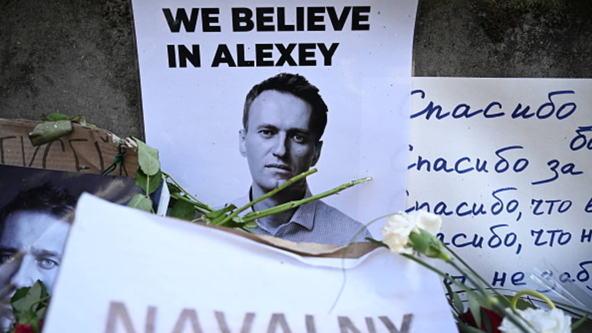 Flowers are seen placed around a portrait of late Russian opposition leader Alexei Navalny at a makeshift memorial in Frankfurt am Main, western Germany, on February 29, 2024. 