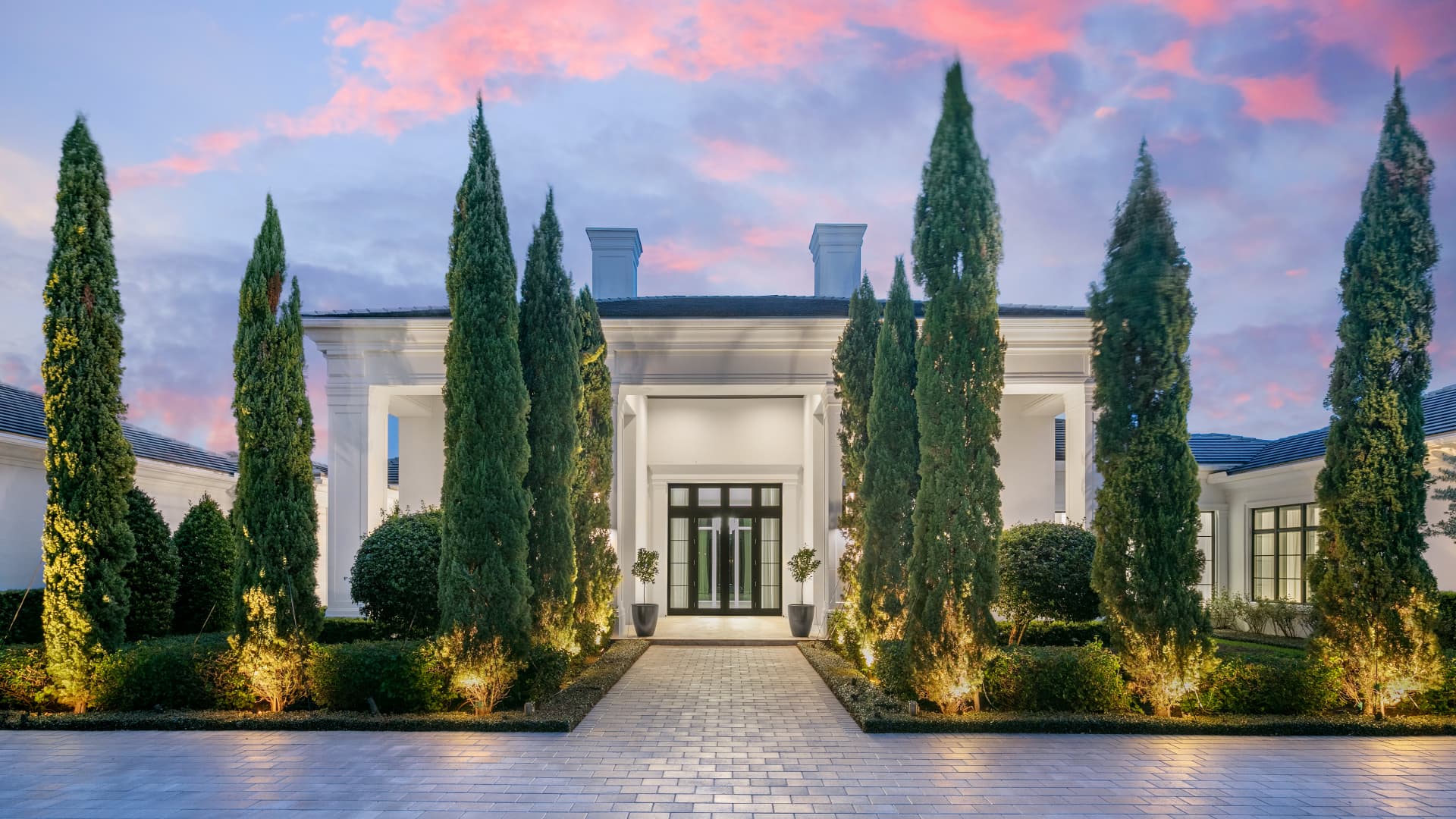 Villa Ananda's entrance is flanked by mature Italian Cypress trees.