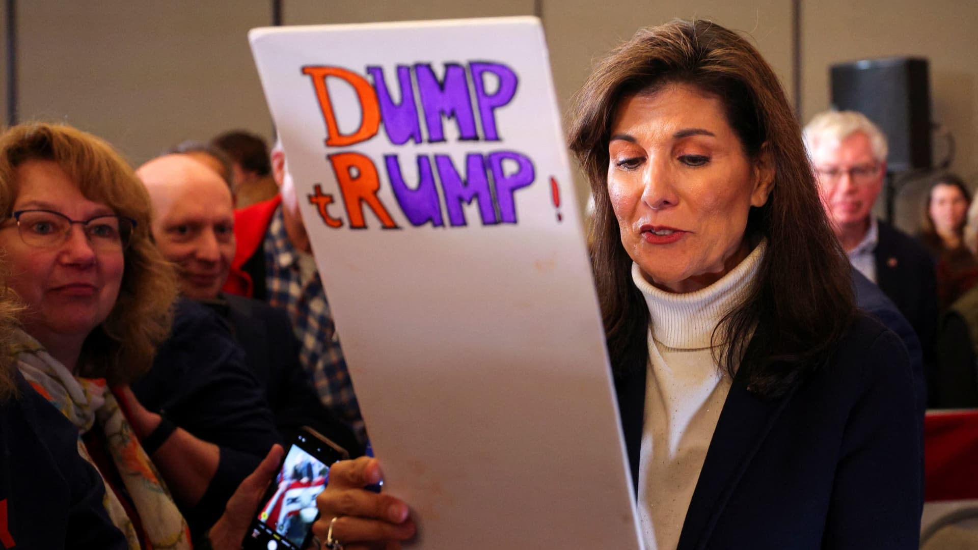 Republican presidential candidate and former U.S. Ambassador to the United Nations Nikki Haley holds a placard, given to her by a member of the audience, during a campaign event in South Burlington, Vermont, U.S. March 3, 2024. 