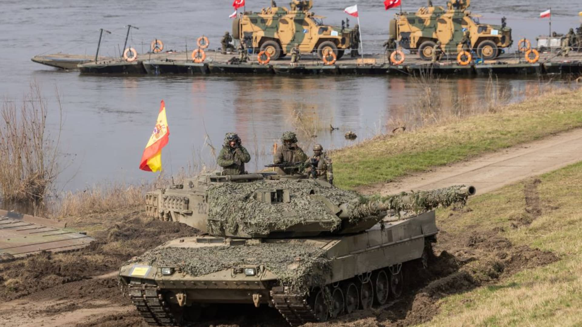 Soldiers from Spain drive a Leopard tank after crossing the Wistula river as they take part in the NATO DRAGON-24 military exercise in Korzeniewo, northern Poland, March 4, 2024.