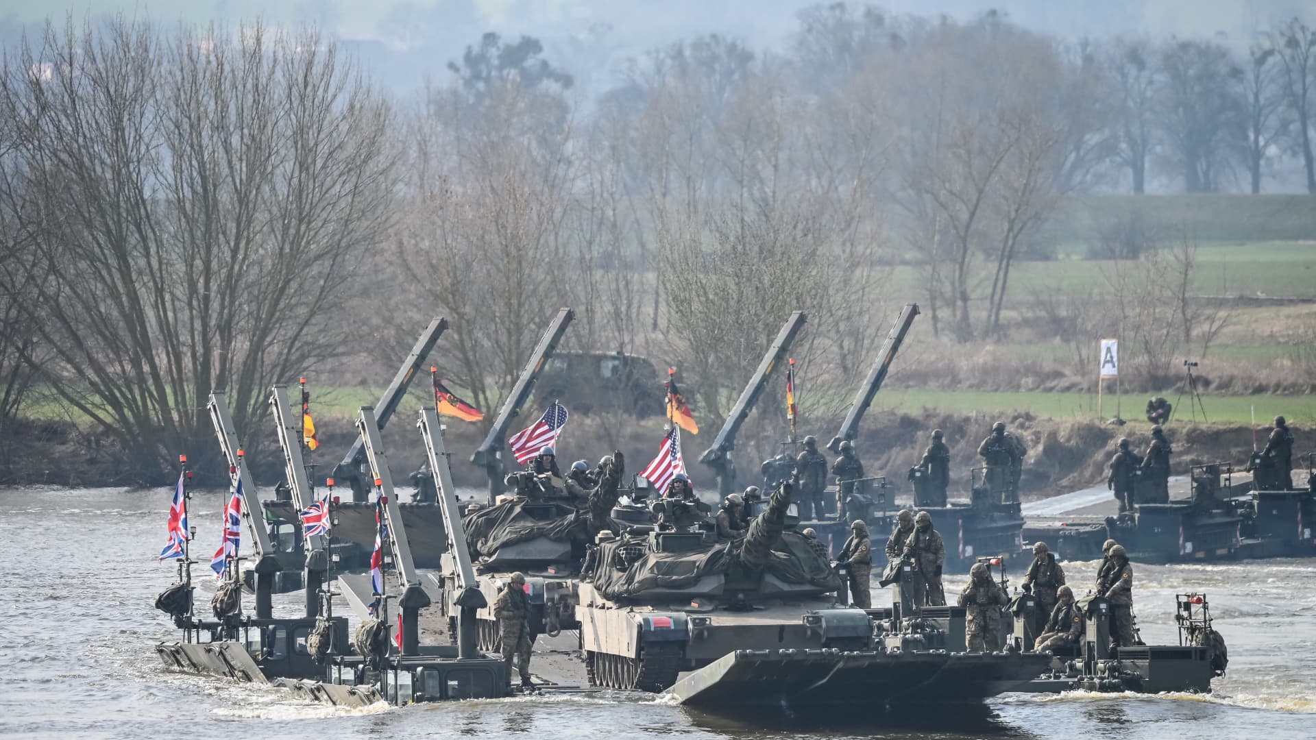 Soldiers cross the Wistula river with Abrams tanks as they take part in the NATO DRAGON-24 military exercise in Korzeniewo, northern Poland, March 4, 2024.