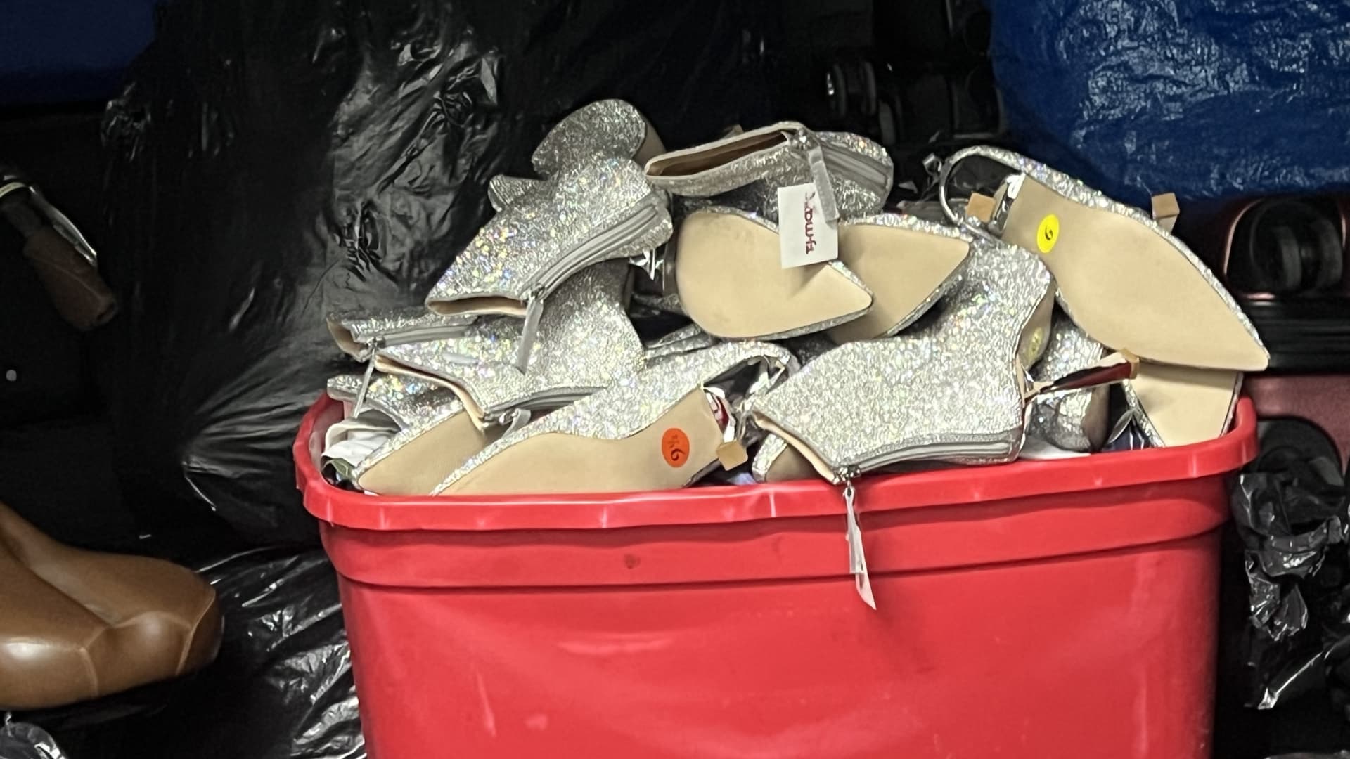 A bin filled with sparkly silver boots that police suspect an alleged San Jose, California, crime ring stole from T.J. Maxx.