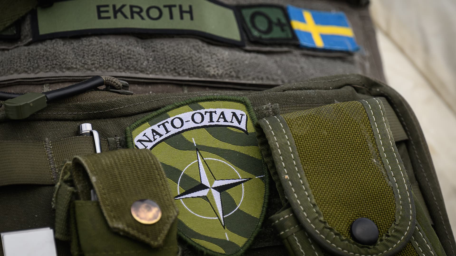 Logistics Battalion Commander Major Anders Ekroth gestures to his NATO badge as he is interviewed at a supply depot during the Nordic Response military exercise on March 08, 2024 in Unspecified - Region EMEA. 