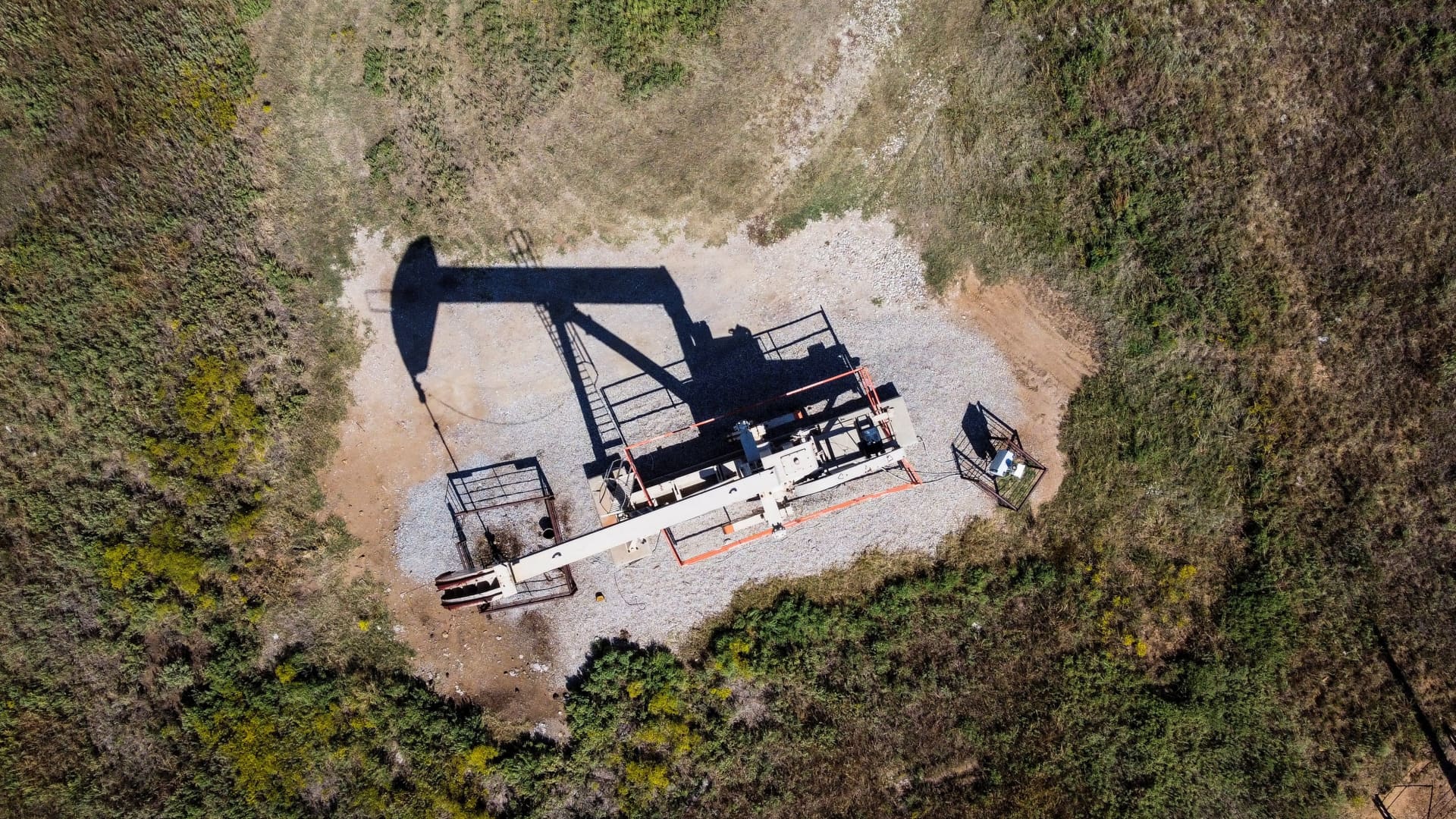 An aerial view shows a pumpjack operating at an oil well in Gray Horse, Oklahoma, on September 29, 2023.