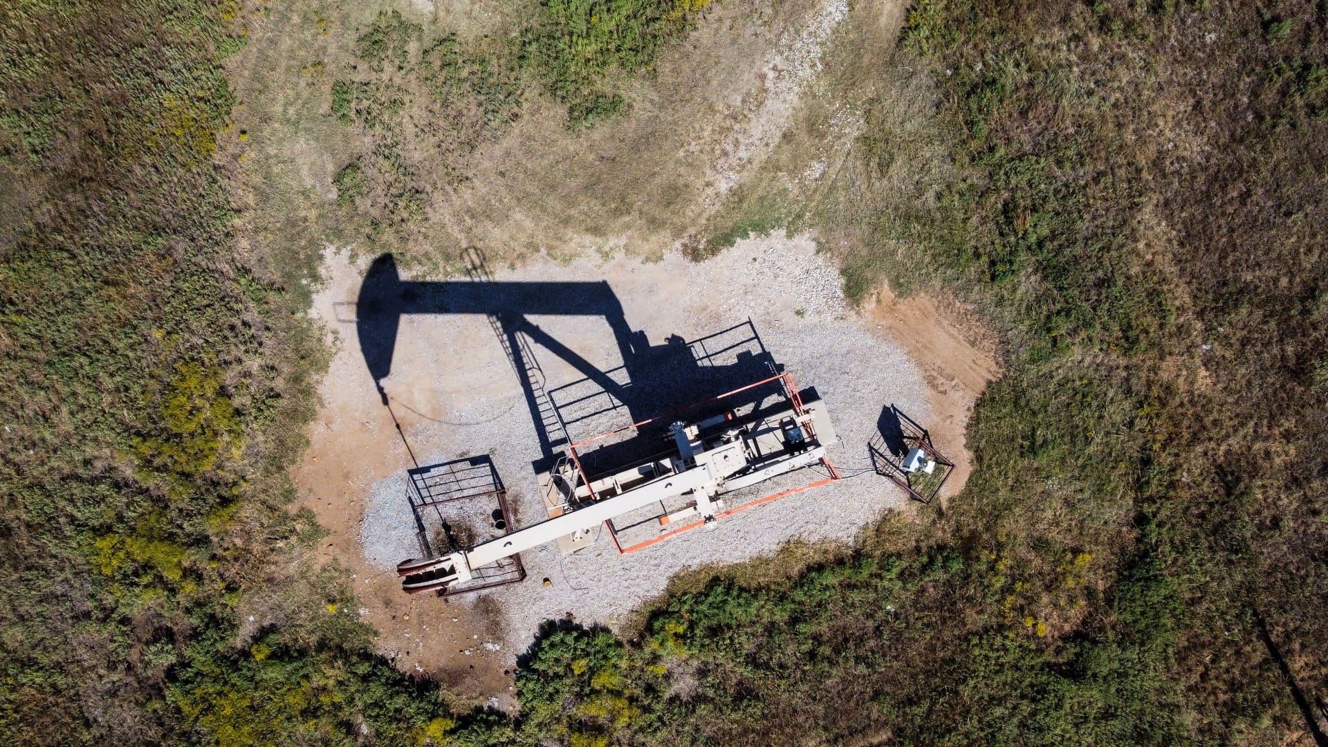 An aerial view shows a pumpjack operating at an oil well in Gray Horse, Oklahoma, on September 29, 2023.