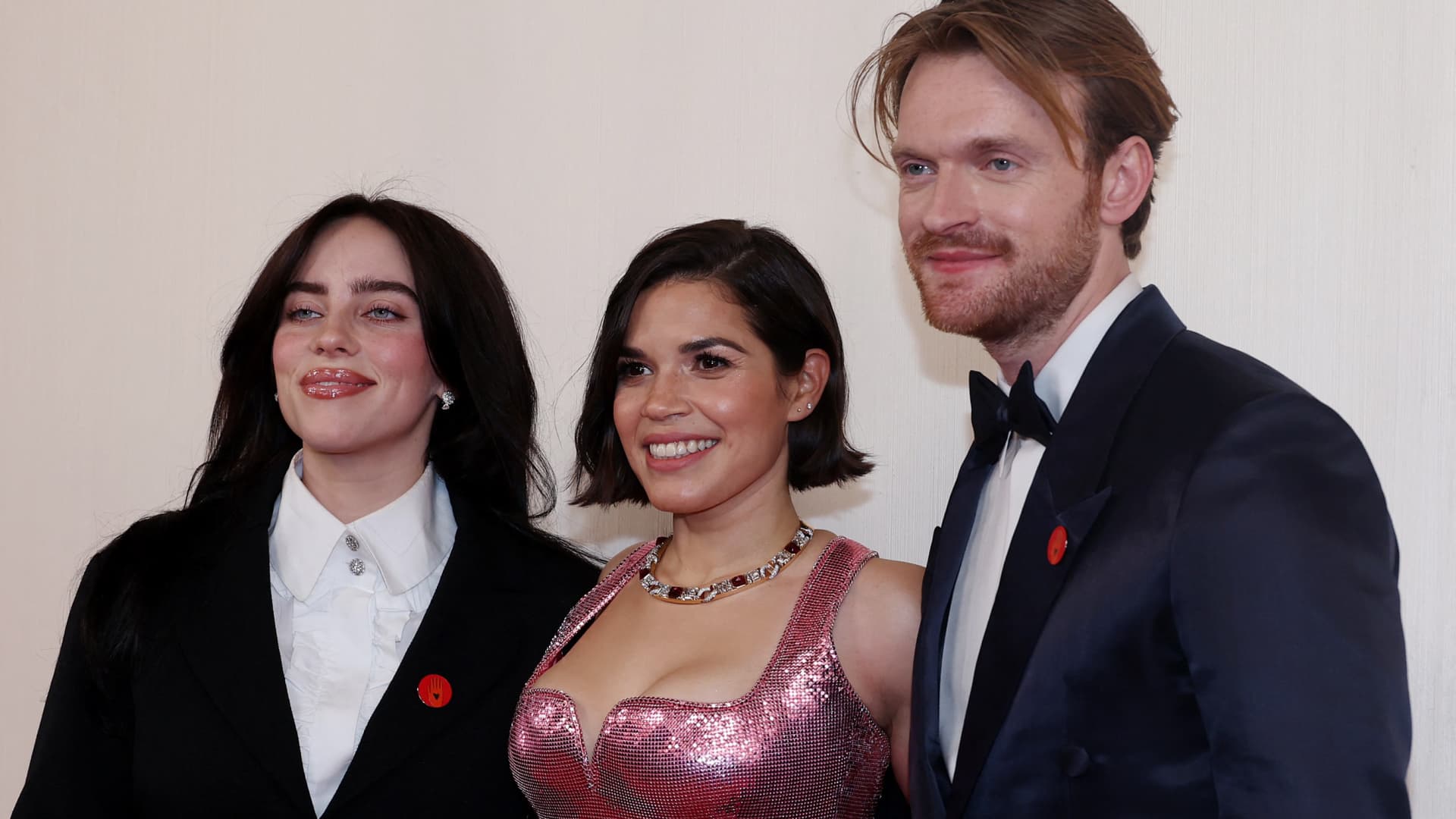 Billie Eilish, America Ferrera and Finneas O'Connell pose on the red carpet during the Oscars arrivals at the 96th Academy Awards in Hollywood, Los Angeles, California, U.S., March 10, 2024.