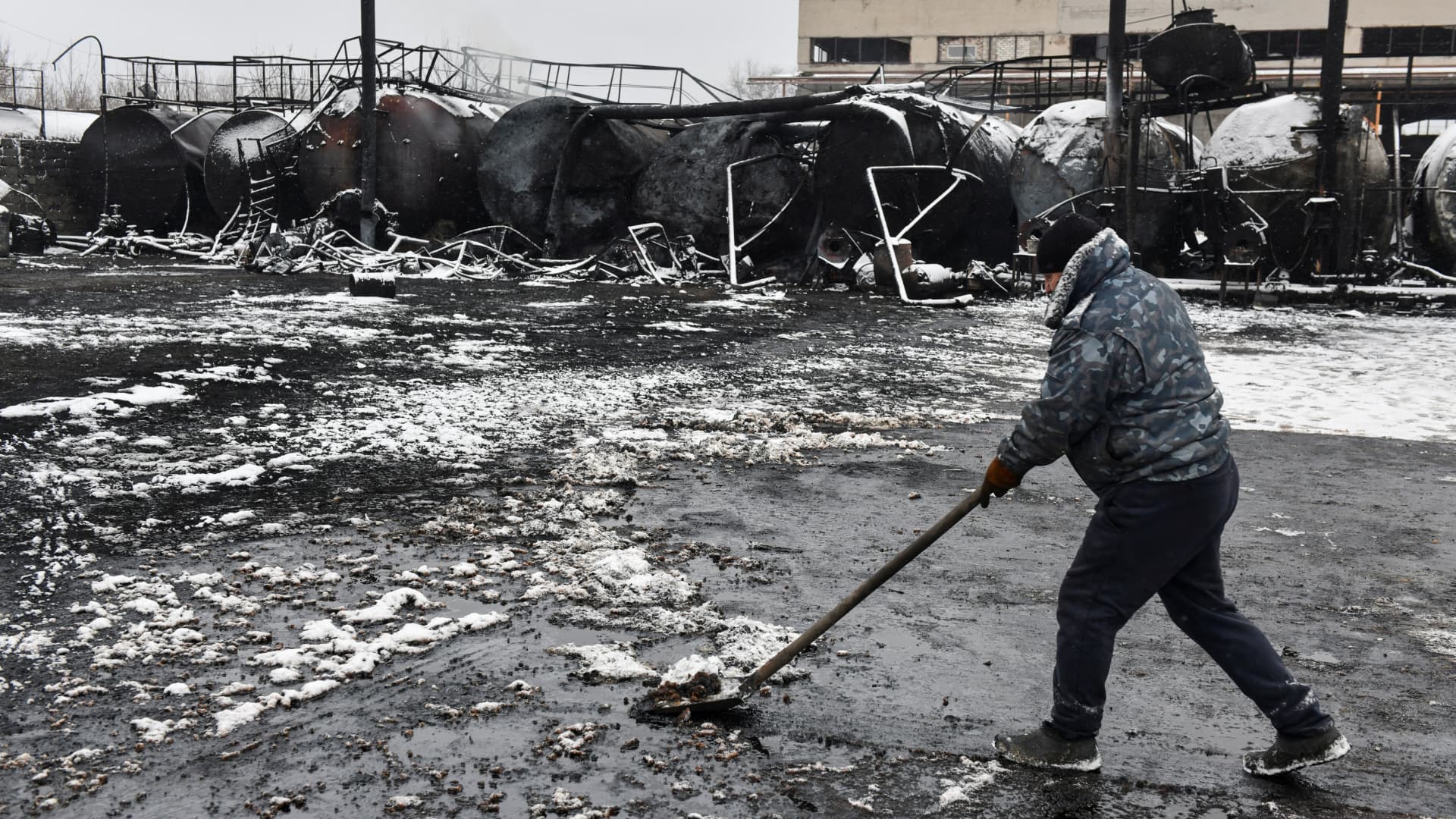 A man cleans up at an oil depot hit by recent shelling in the course of Russia-Ukraine conflict in Donetsk, Russian-controlled Ukraine, December 7, 2023.