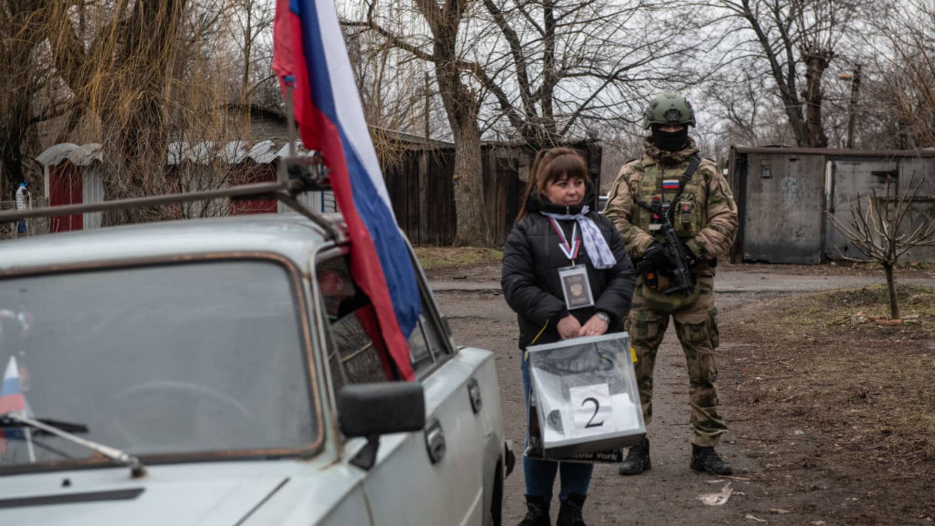 A member of a local election commission, accompanied by a serviceman, visits voters during early voting in Russia's presidential election in Donetsk, Russian-controlled Ukraine, amid the Russia-Ukraine conflict on March 14, 2024.