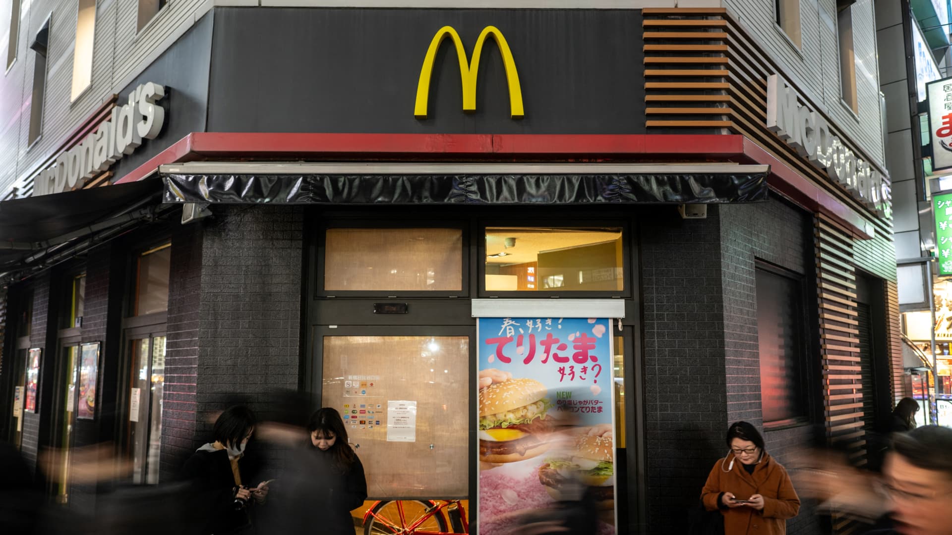 People stand in front of a temporary closed McDonald's in Shimbashi district of Tokyo on March 15, 2024. Hungry McDonald's customers in parts of Asia had trouble ordering at stores, on cellphones and at electronic kiosks after a system outage. 