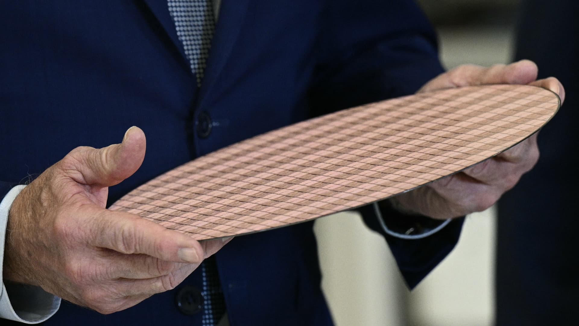 US President Joe Biden holds a wafer of chips as he tours the Intel Ocotillo Campus in Chandler, Arizona, on March 20, 2024.