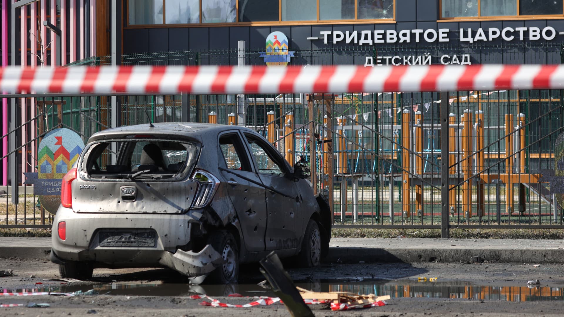 A damaged car is seen in front of a kindergarten following fresh aerial attacks in Belgorod on March 20, 2024. 