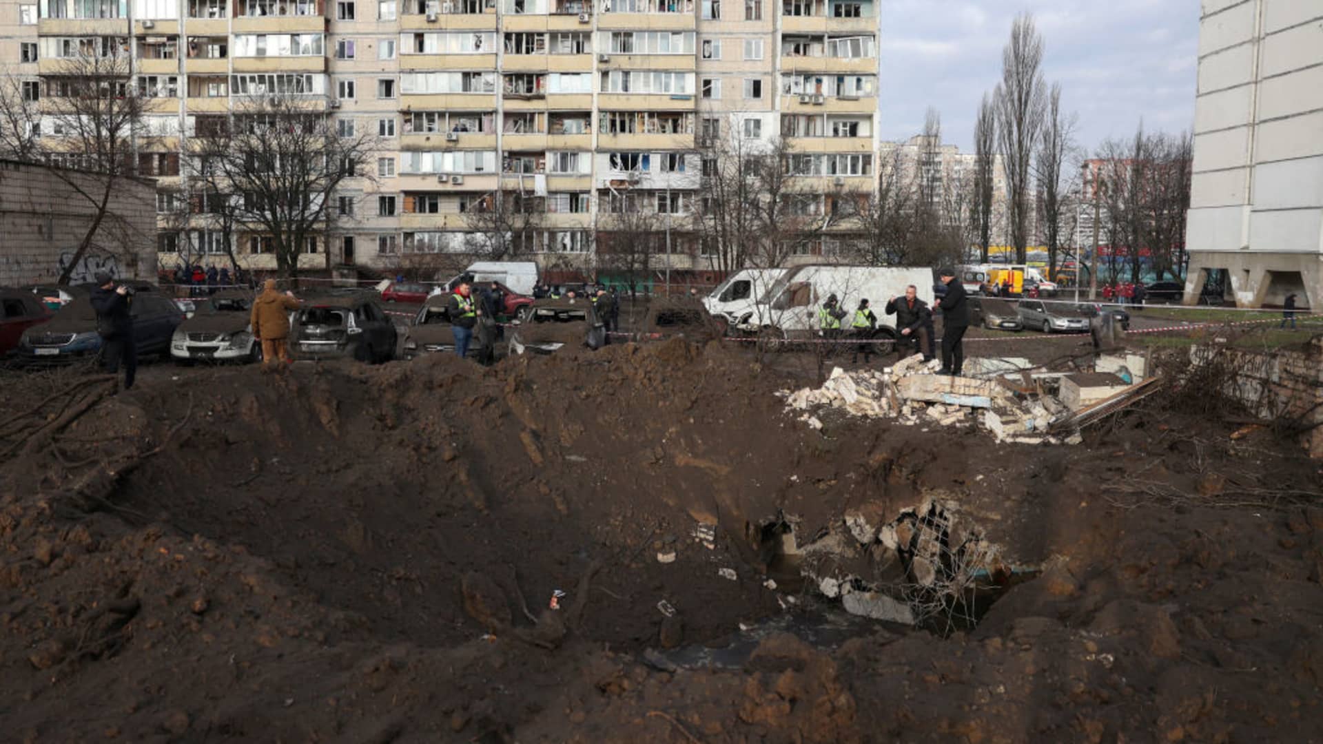 Police officers inspect an explosion crater after a missile attack in Kyiv, on March 21, 2024, amid the Russian invasion in Ukraine.