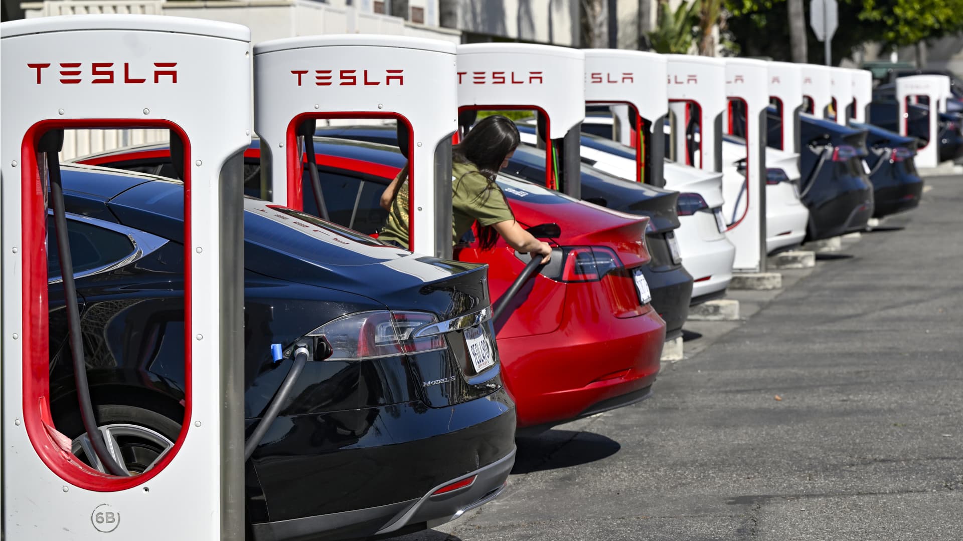 Drivers charge their Teslas in Fountain Valley, California, on March 20, 2024.