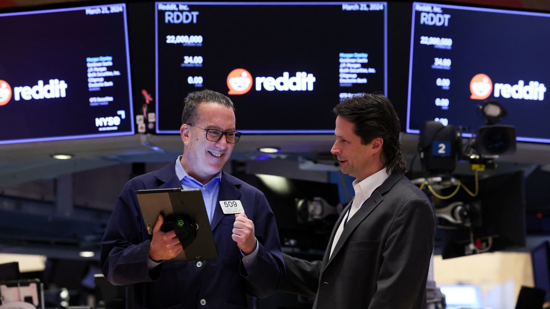 Traders work as Reddit's logo is displayed at the New York Stock Exchange on March 21, 2024.