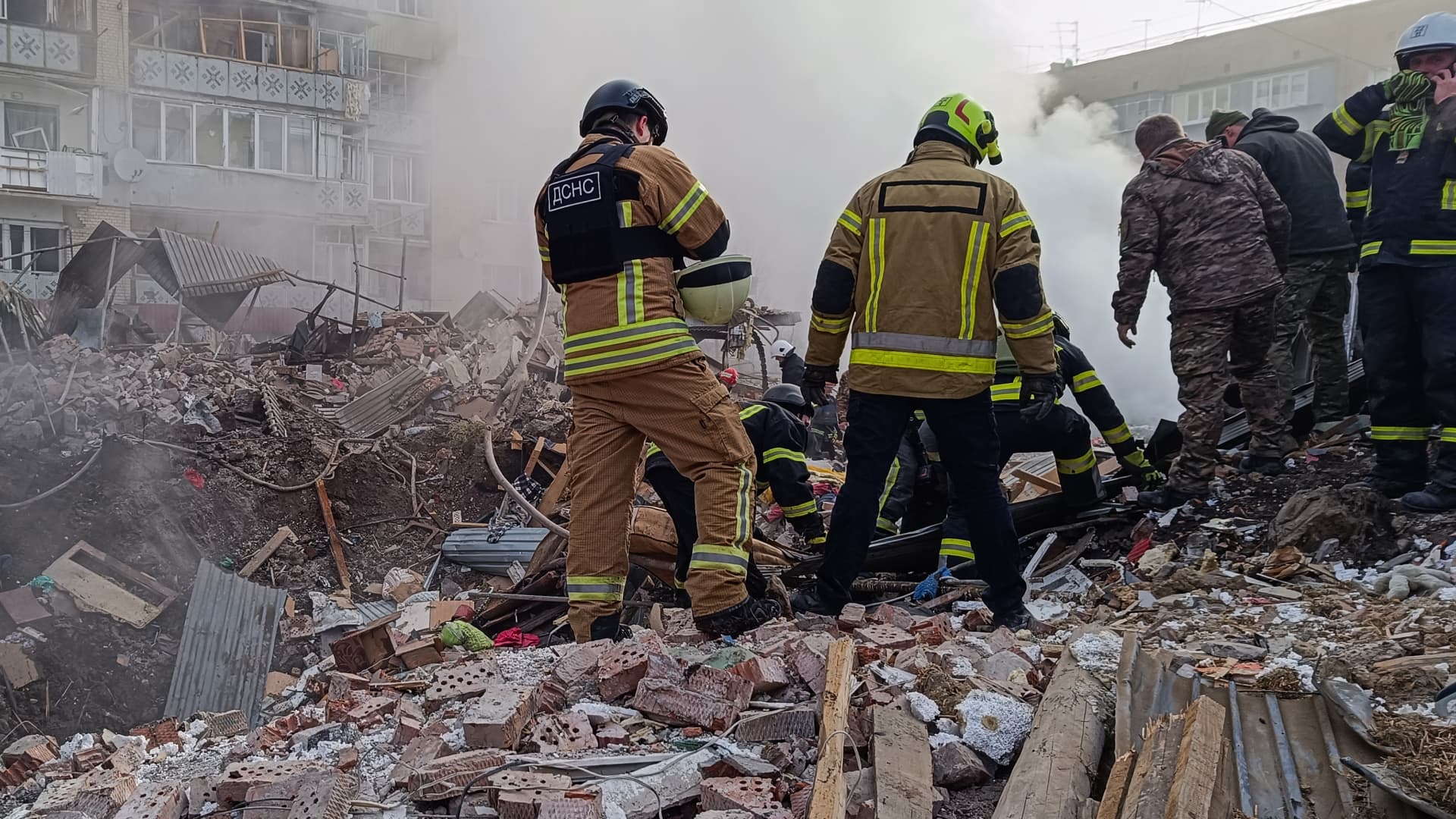 Rescuers remove the body of a man, an owner of a private residential building hit by a Russian missile, from under the rubble on March 22, 2024 in Khmelnytskyi, Ukraine.