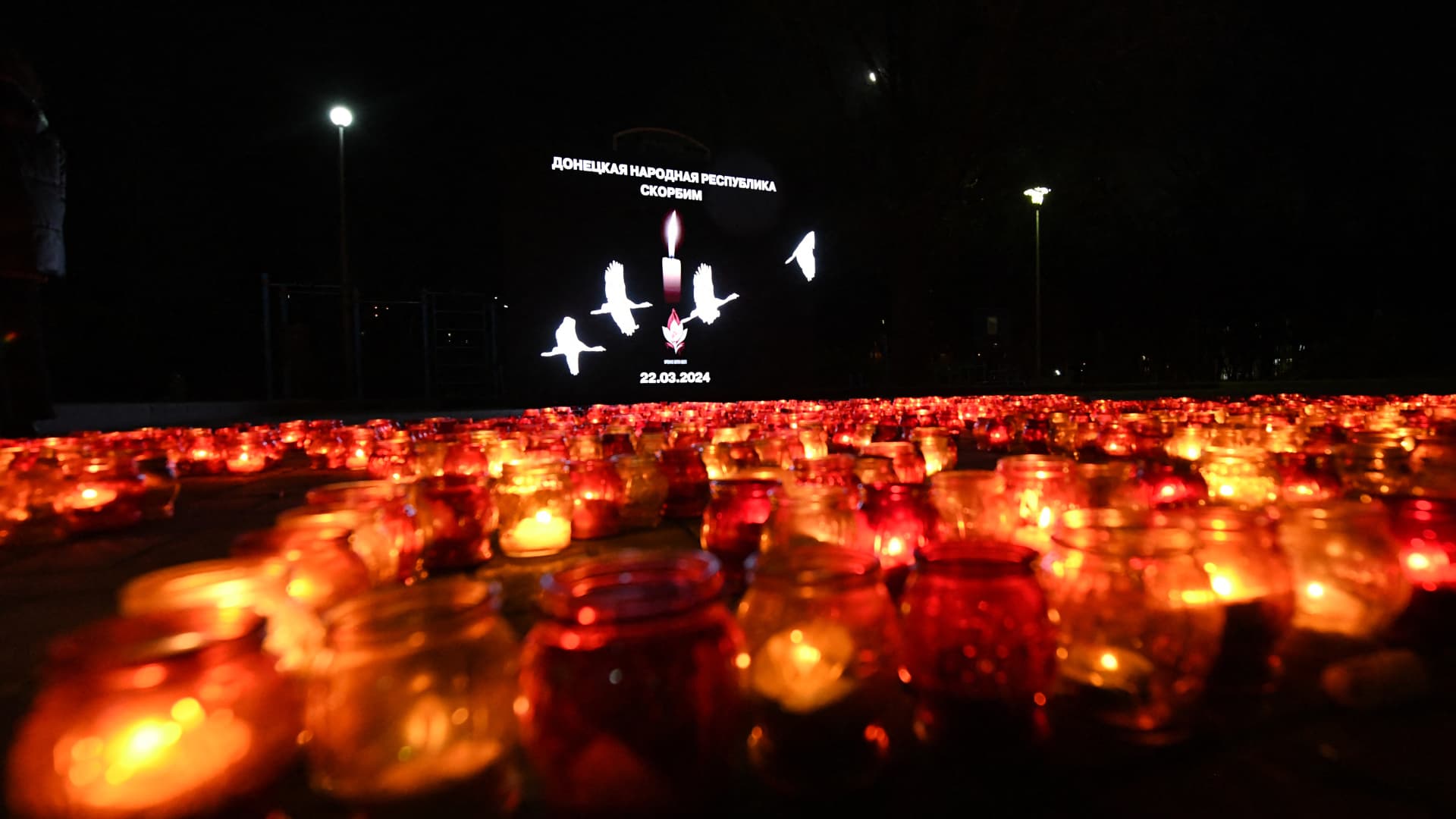 People light candles during a memorial gathering in Donetsk, Russian-controlled Ukraine, on March 24, 2024, as Russia observes a national day of mourning after a Moscow concert hall massacre that killed more than 130 people.