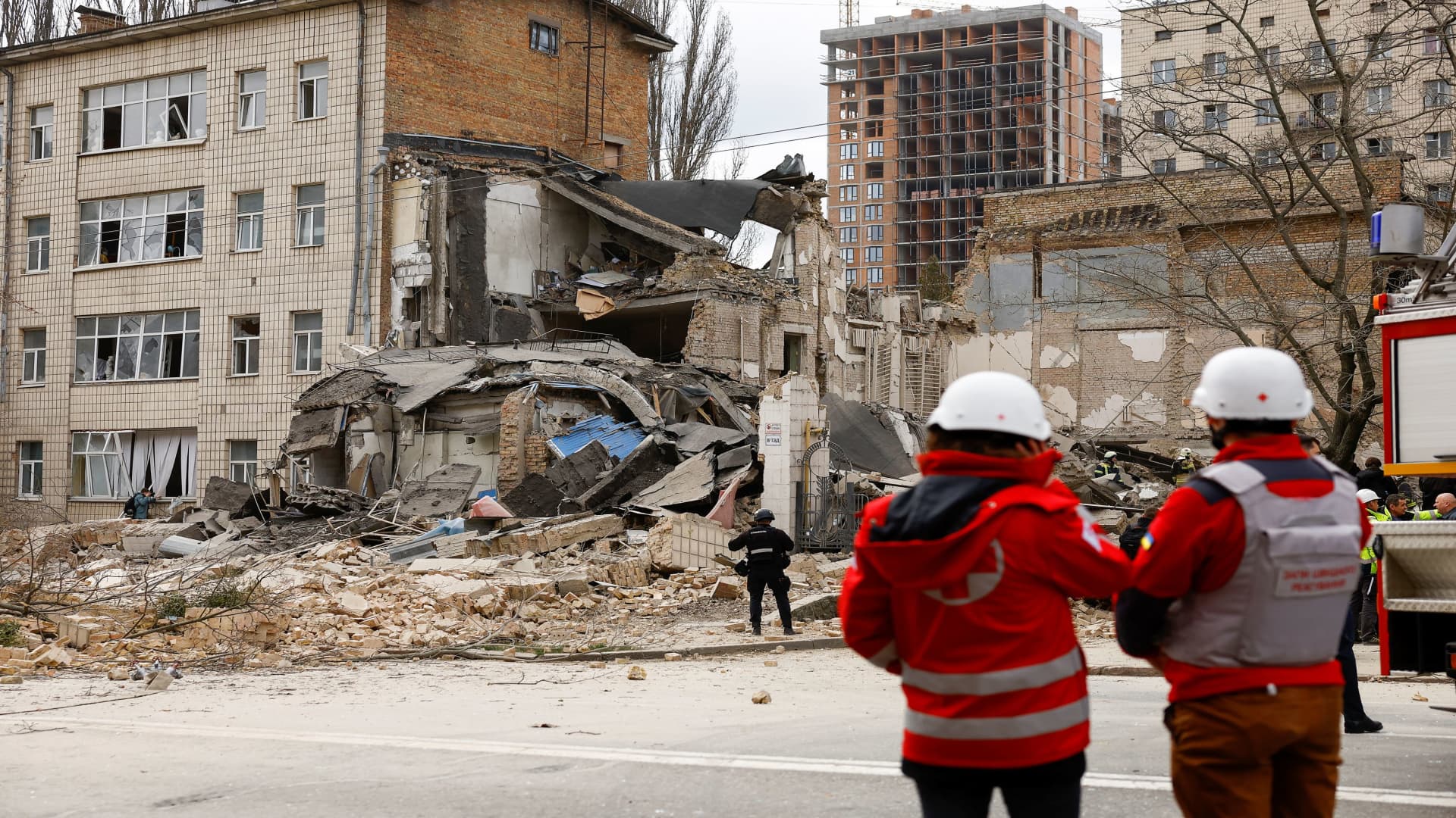Rescuers work at the site of a building damaged by a Russian missile strike, amid Russia's attack on Ukraine, in Kyiv, Ukraine, March 25, 2024.