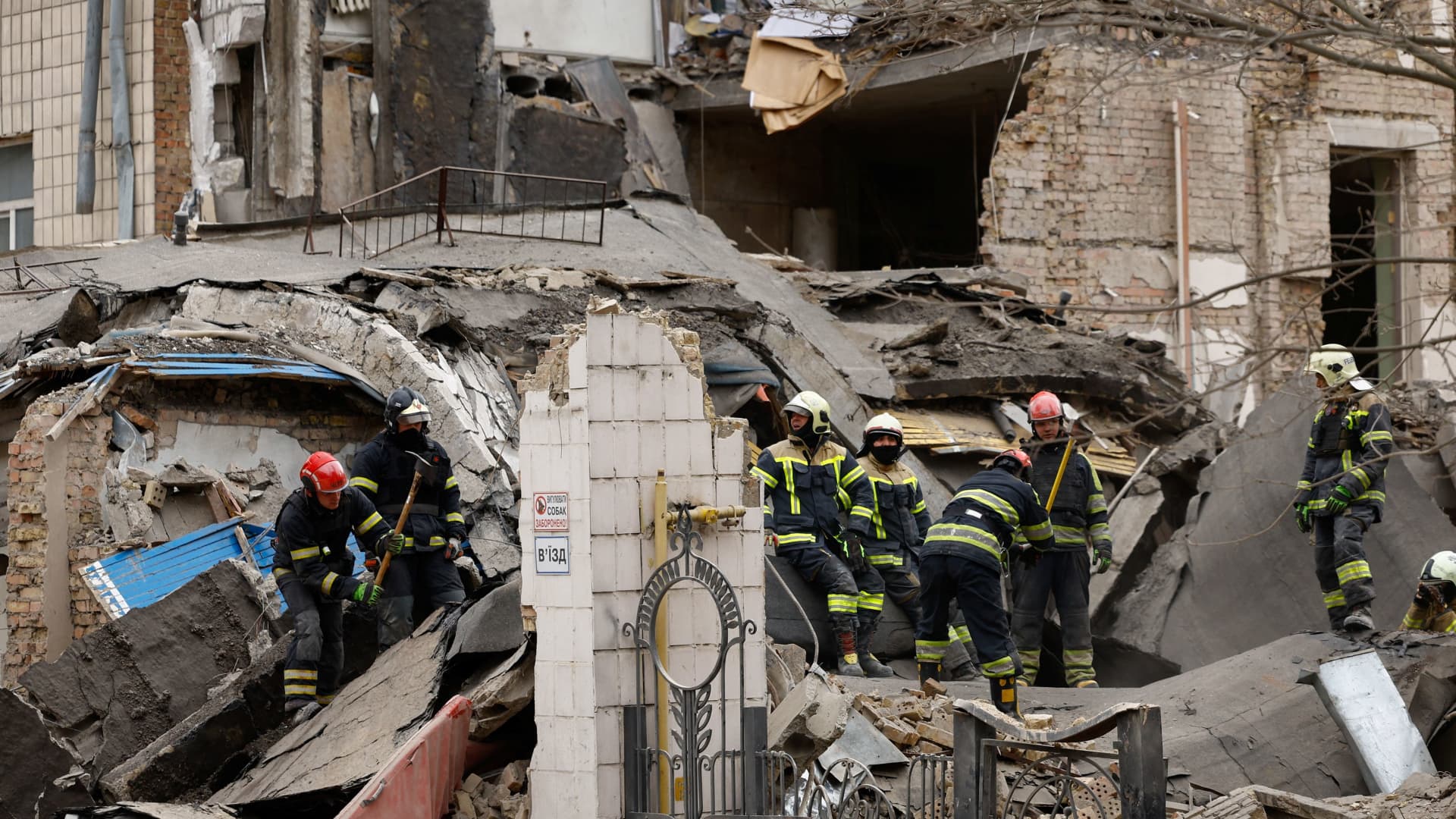Rescuers work at the site of a building damaged by a Russian missile strike, amid Russia's attack on Ukraine, in Kyiv, Ukraine, March 25, 2024. 