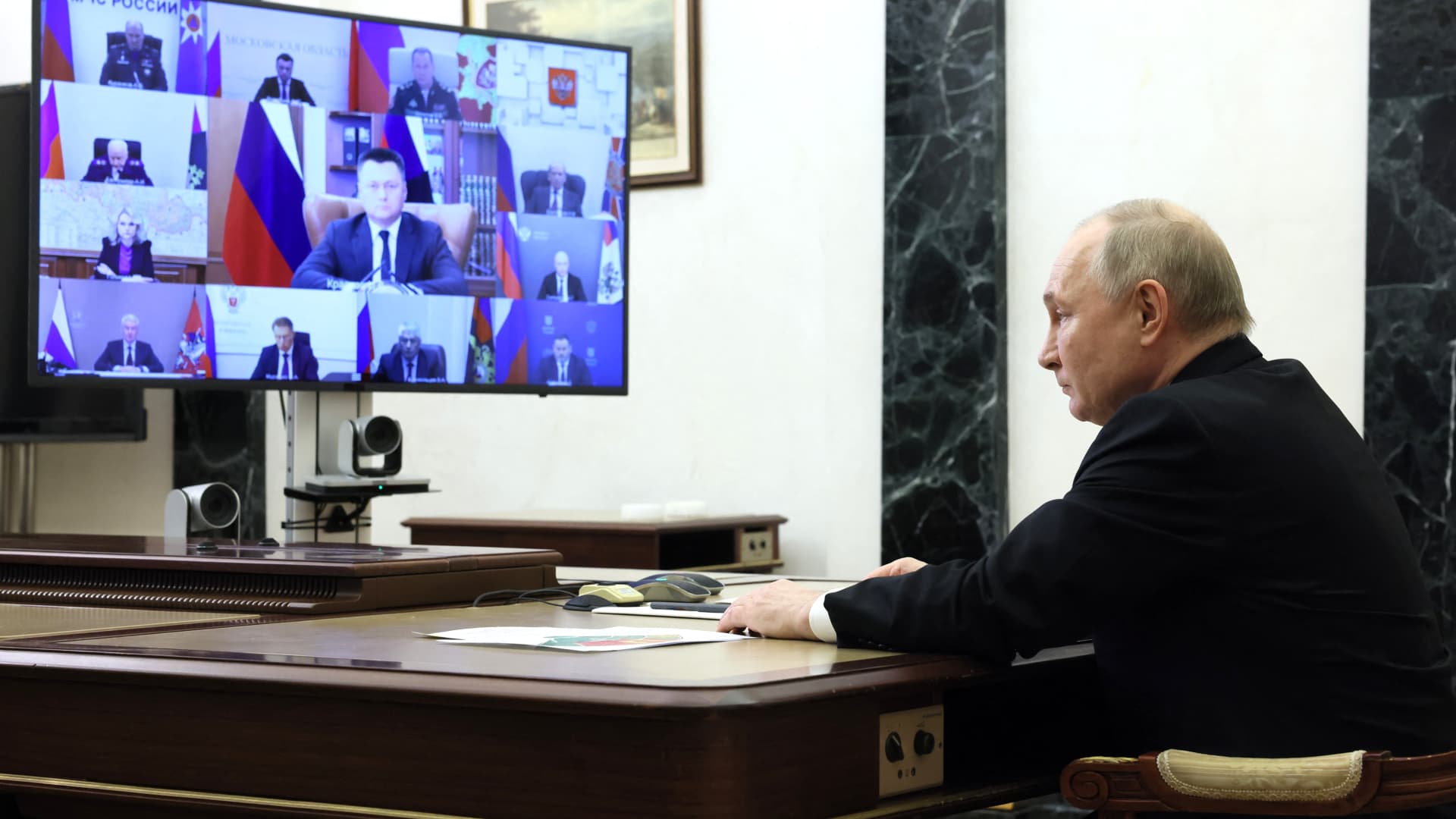 In this pool photograph distributed by the Russian state agency Sputnik, Russia's President Vladimir Putin holds a meeting on measures taken after a massacre in the Crocus City Hall that killed more than 130 people, the deadliest attack in Europe to have been claimed by the Islamic State (IS) group, via a videoconference at the Novo-Ogaryovo state residence, outside Moscow, on March 25, 2024.