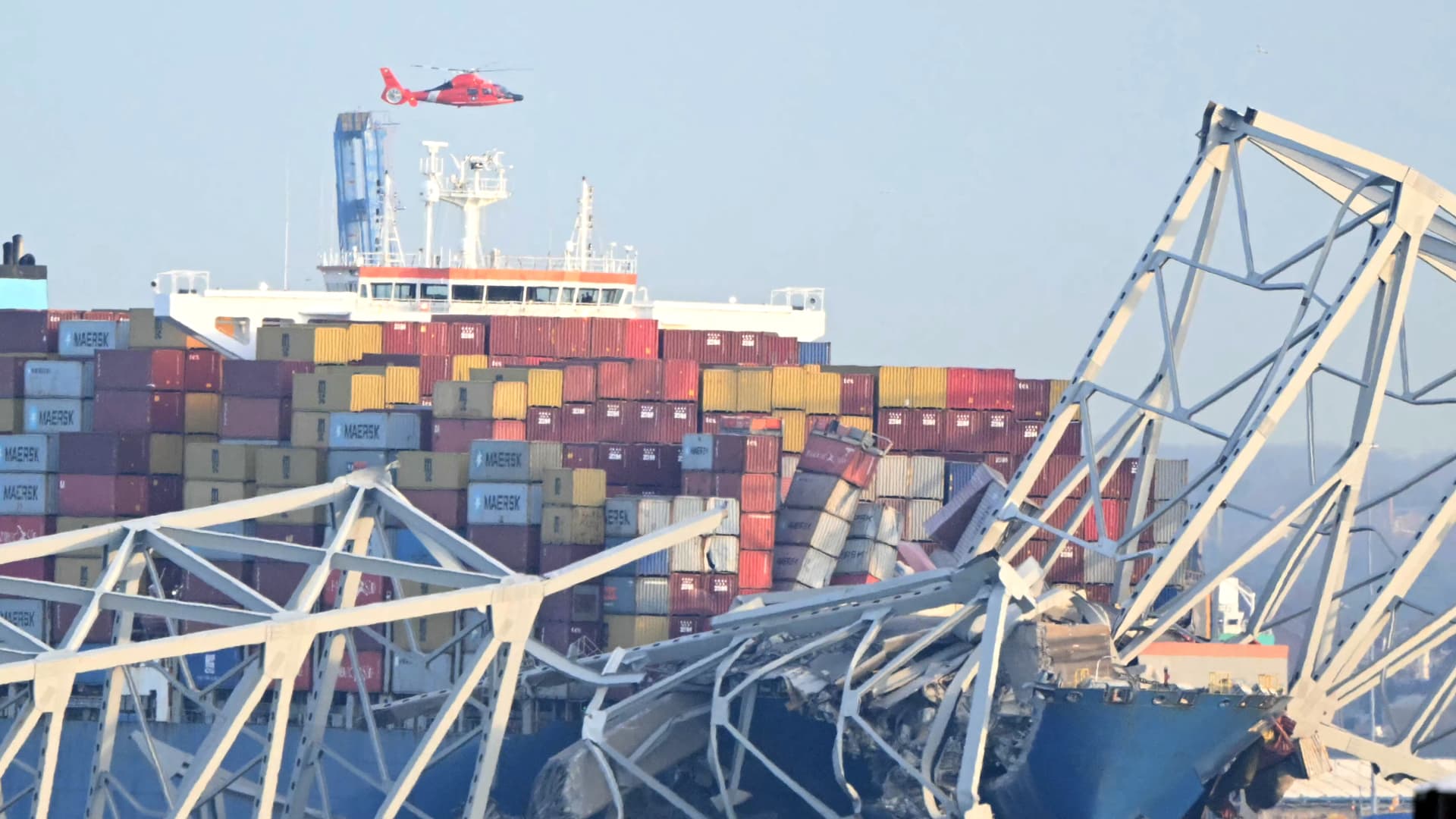 The steel frame of the Francis Scott Key Bridge sit on top of a container ship after the bridge collapsed collapsed in Baltimore, Maryland, on March 26, 2024. 
