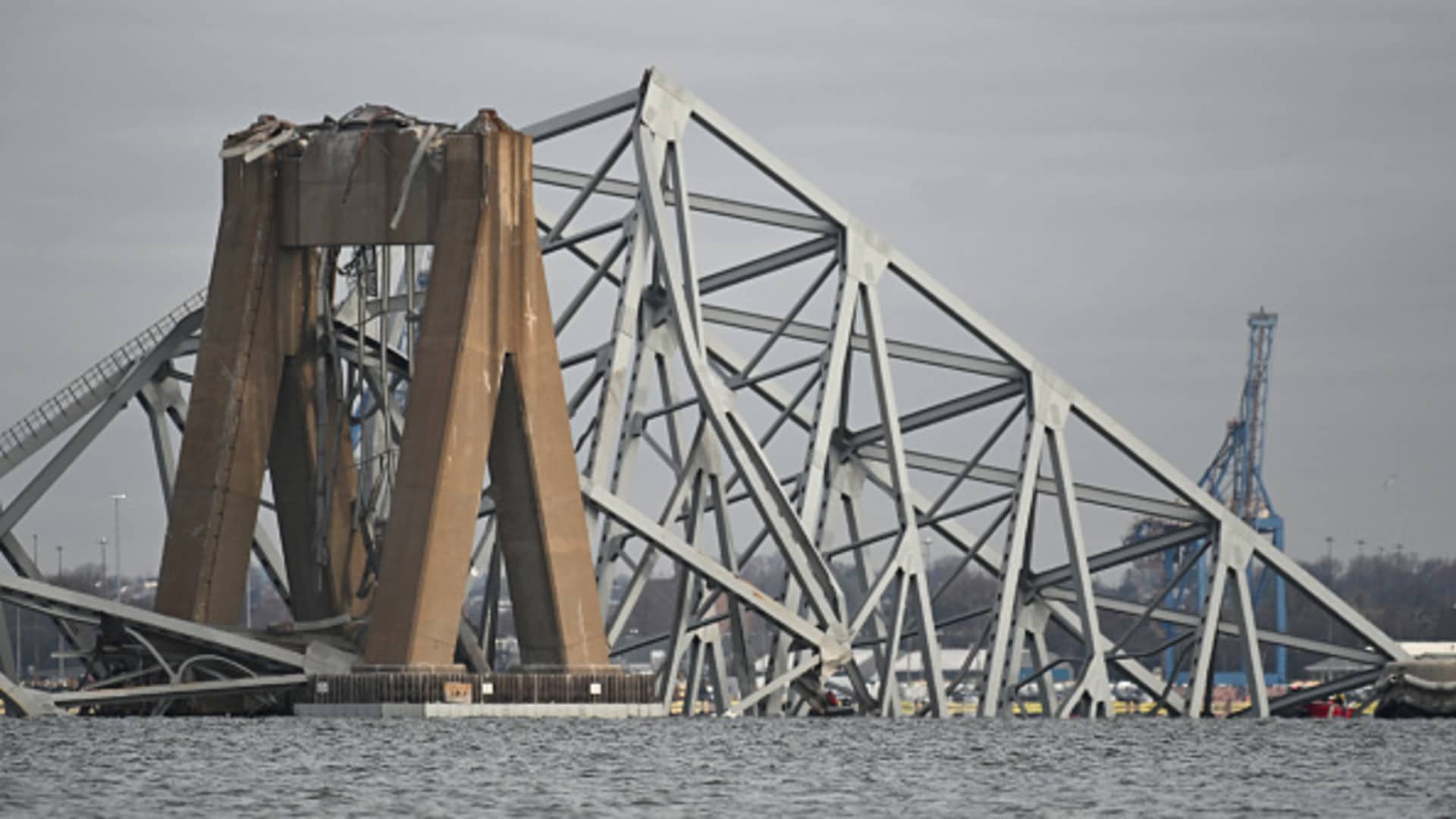 The steel frame of the Francis Scott Key Bridge lies in the water after it collapsed in Baltimore, Maryland, on March 26, 2024.