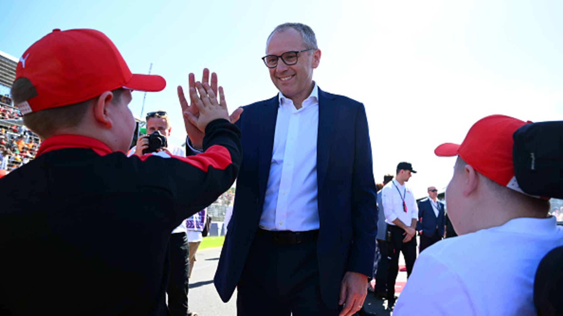 Stefano Domenicali, CEO of the Formula One Group, interacts with Grid Kids on the grid prior to the F1 Grand Prix of Australia at Albert Park Circuit on March 24, 2024.