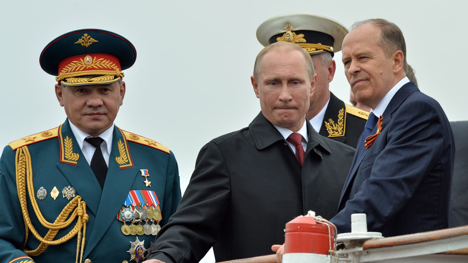 Russian President Vladimir Putin (C) reviews Russian naval ships in the Crimean port of Sevastopol on May 9, 2014, with head of the Federal Security Service (FSB) Alexander Bortnikov (R) and Defence Minister Sergei Shoigu (L) attending. 