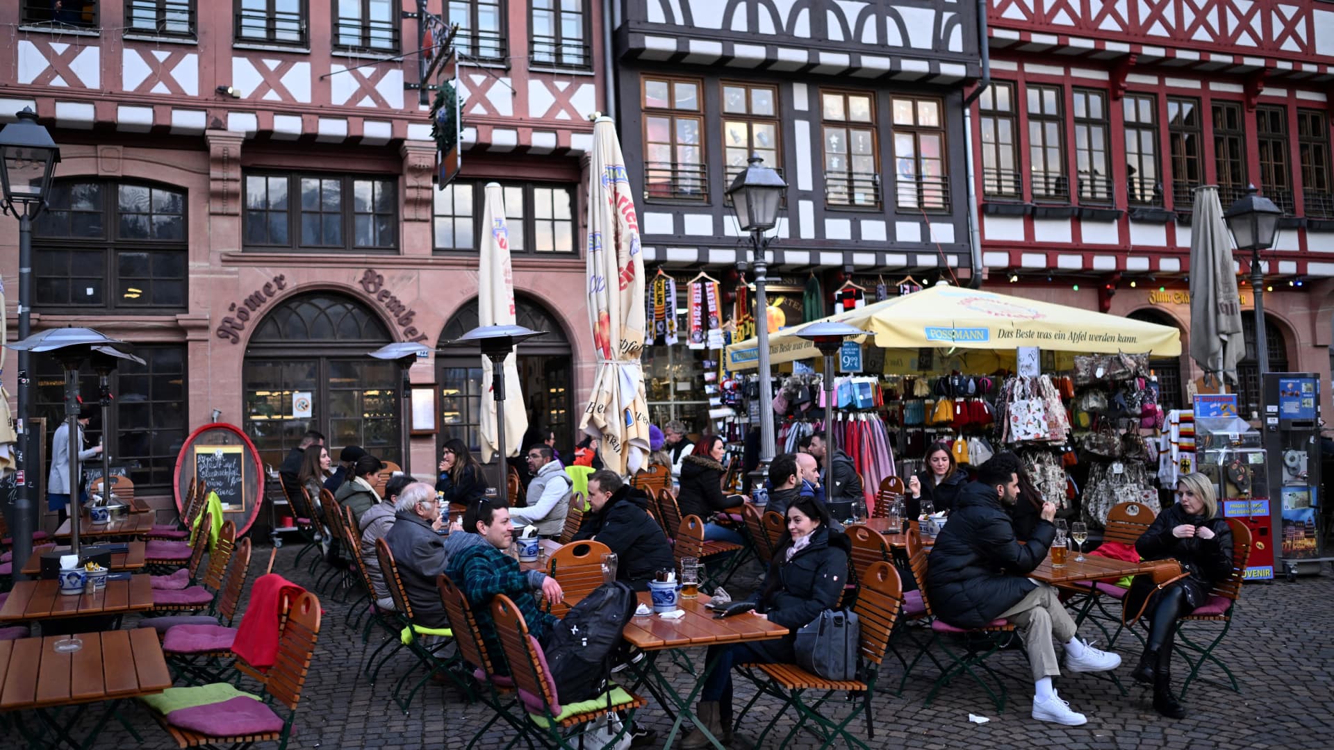 Customers sit at tables of a street cafe on the central Roemer Square in Frankfurt am Main, western Germany, on February 28, 2024.