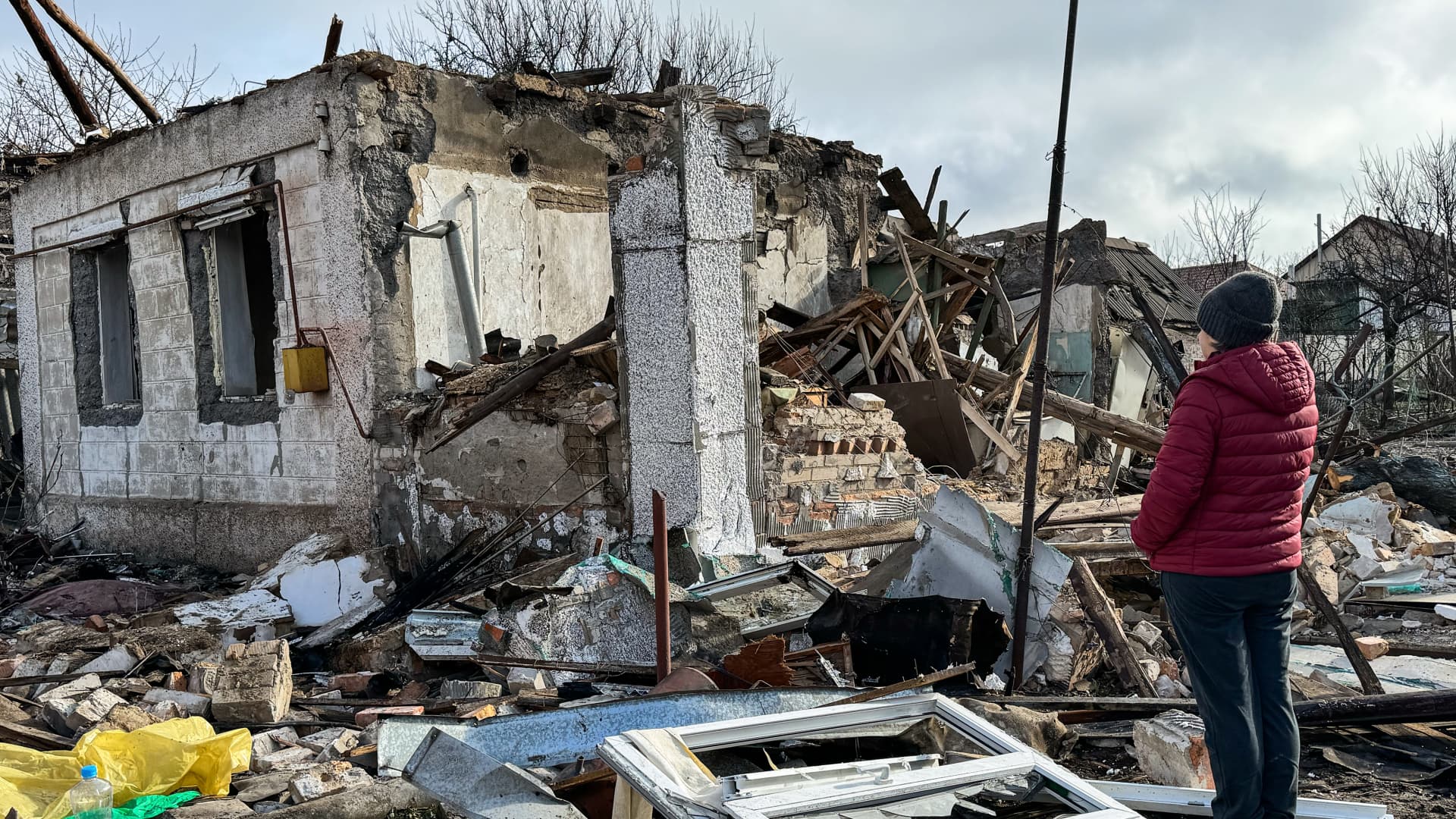 A woman looks at a destroyed private home after a Russian drone attack on March 28, 2024 in Zaporizhzhia, Ukraine.