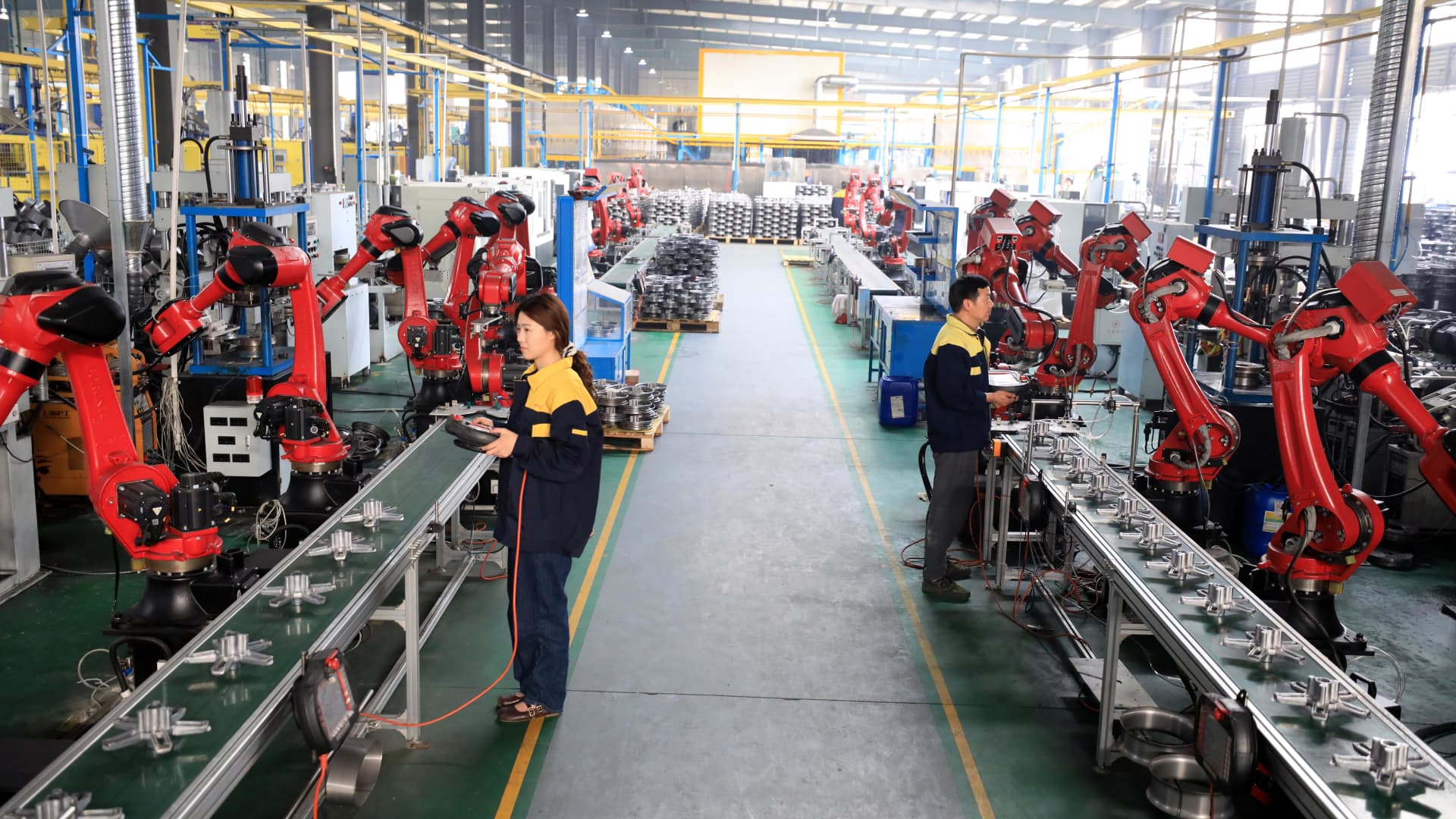 Employees work on the production line of motorcycle and electric bicycle wheel hubs at a factory in Huaibei, Anhui Province of China, on March 30, 2024.