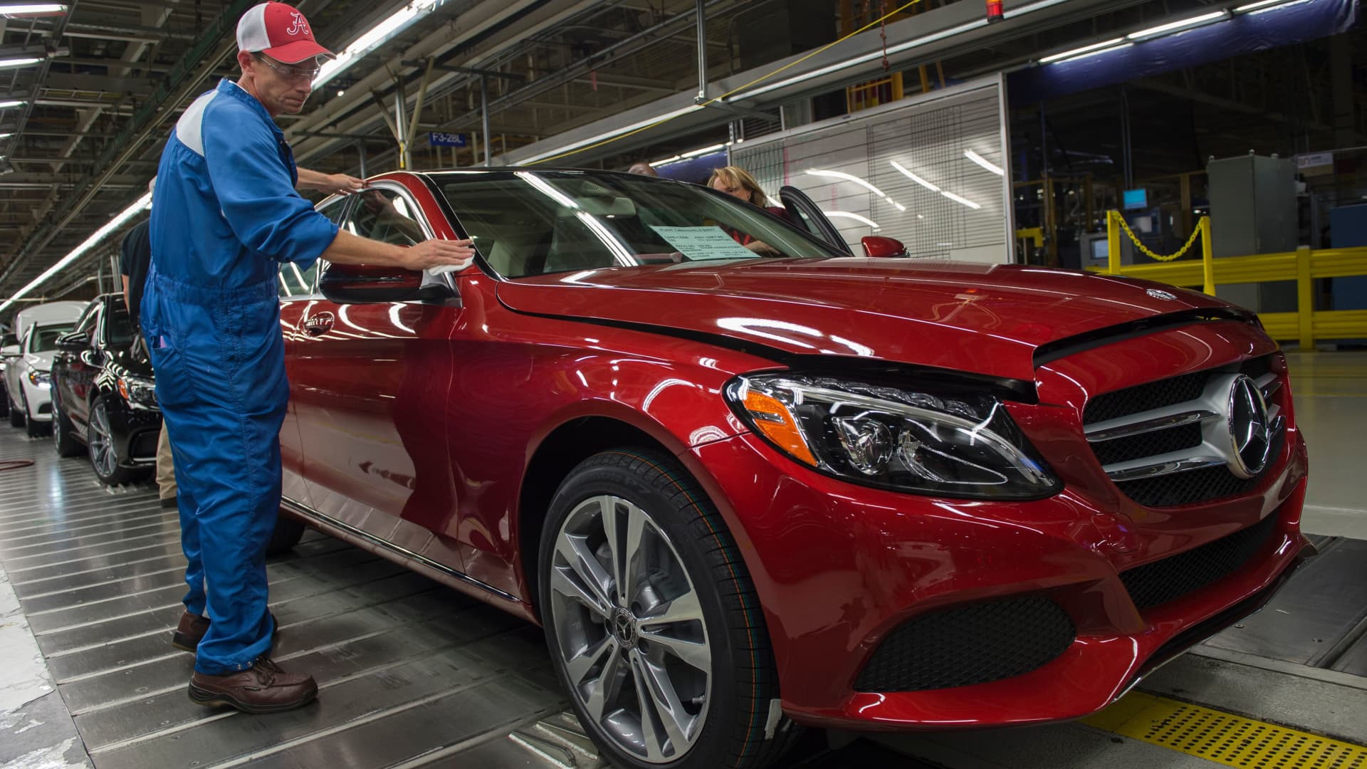 An employee does final inspections on a Mercedes-Benz C-Class at the Mercedes-Benz US International factory in Vance, Alabama on June 8, 2017.