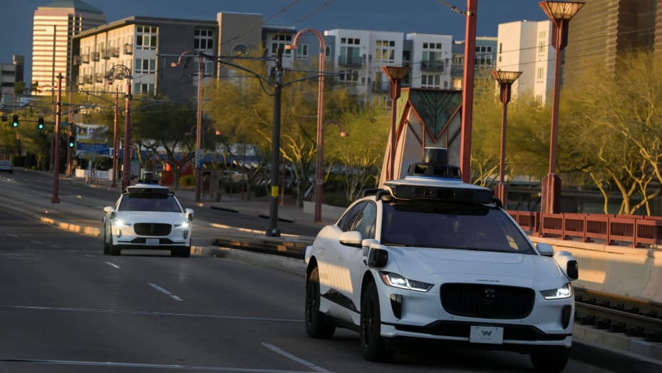 Two Waymo autonomous vehicles drive themselves down Central Avenue in Phoenix, Arizona, U.S., March 18, 2024. REUTERS/Caitlin O'Hara