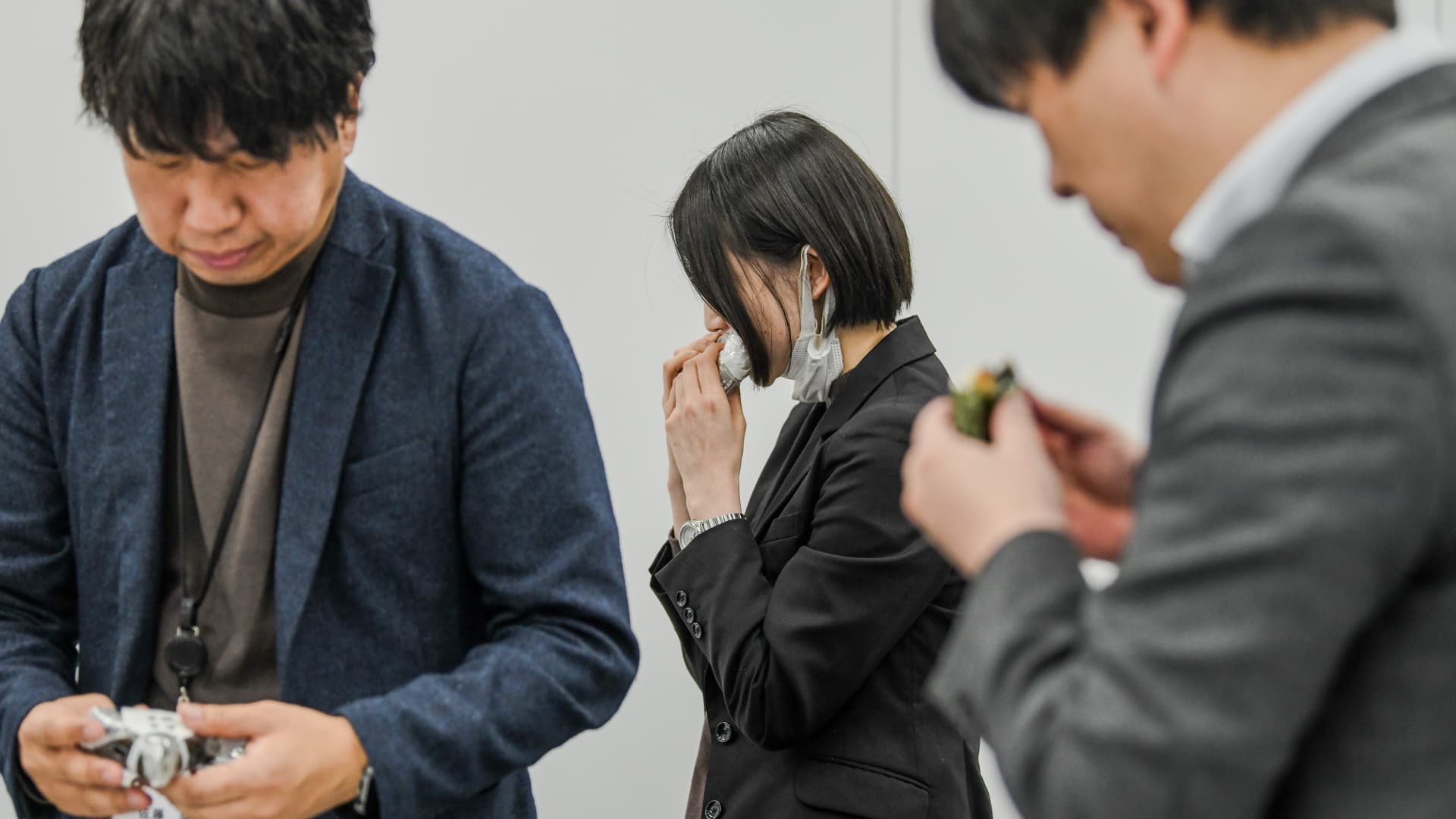 Participants taste onigiri at a product meeting for 7-Eleven Japan in Tokyo on Jan. 23, 2024. Staff and suppliers gathered to discuss flavors, textures and fillings for the Japanese riceballs, one of 7-Eleven's most important products, with more than 2 billion sold each year.