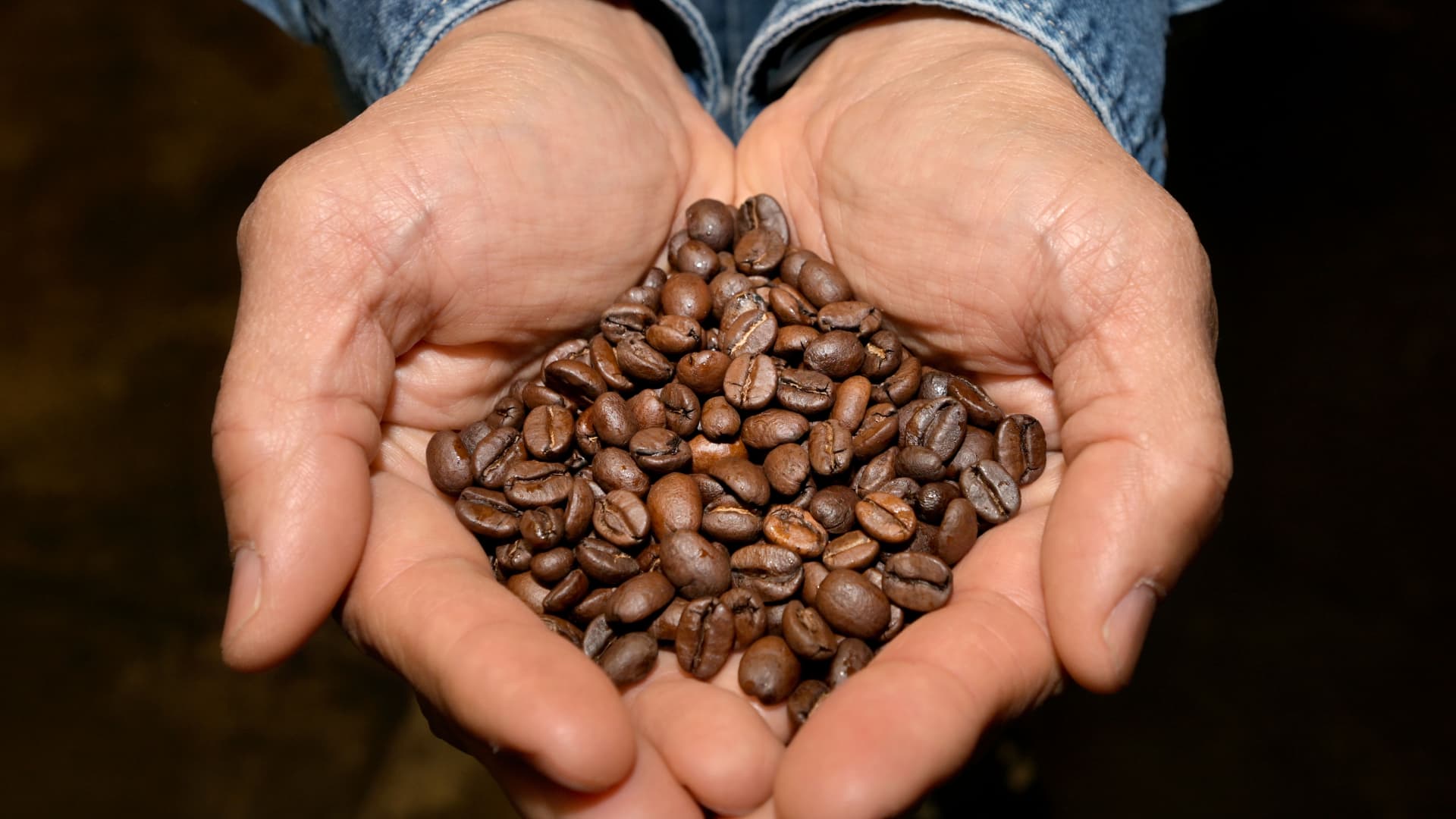 Gary Chau holds fresh beans at the roastery and headquarters for Caffe Luxxe in Gardena on Thursday, March 28, 2024. The South Bay based Caffe Luxxe, a third-wave independent coffee shop has opened a new Manhattan Beach location.