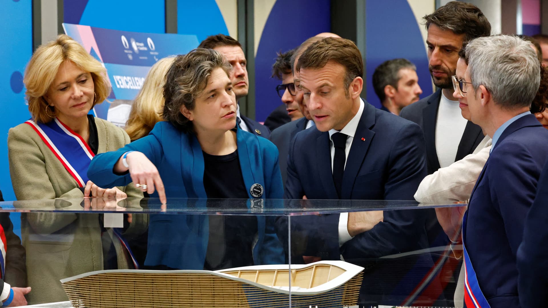 French President Emmanuel Macron (C), president of the Paris 2024 Olympics Organising Committee Tony Estanguet (3rd R), Ile-de-France's Regional Council President Valerie Pecresse (L), and officials look at a model during a visit to the Olympic aquatics centre (CAO), a multifunctional venue for the Paris 2024 Olympics, on the day of its inauguration in Saint-Denis, outside Paris, on April 4, 2024.