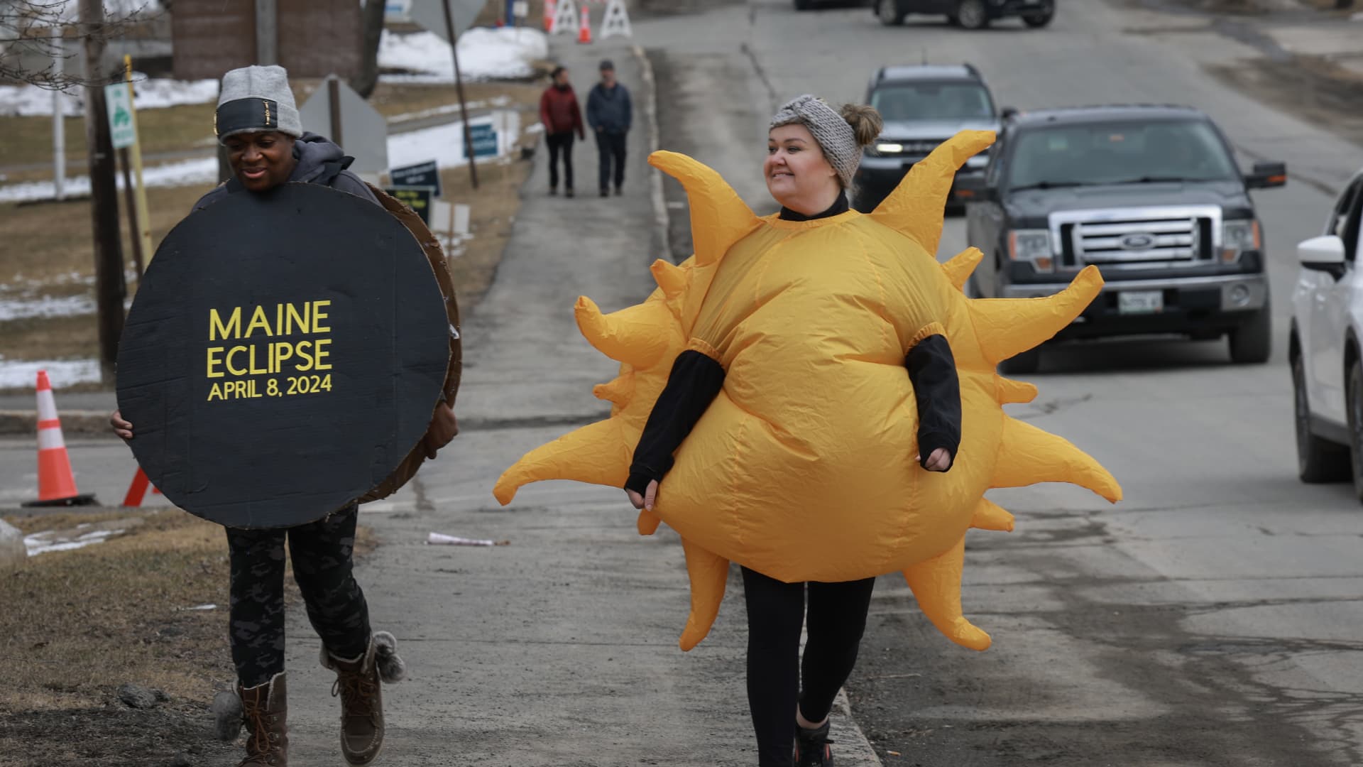 Cheryll Simmons-Heit, wearing a moon, and Johanna Johnston, wearing a sun, participate in the Solar Sprint 3k on April 07, 2024 in Houlton, Maine. 