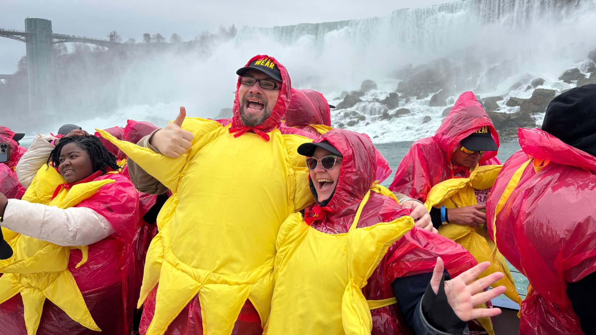 Some of the 309 people gathered to break the Guinness World Record for the largest group of people dressed as the sun pose on a sightseeing boat, before the total solar eclipse in Niagara Falls, Ontario, Canada April 8, 2024. 