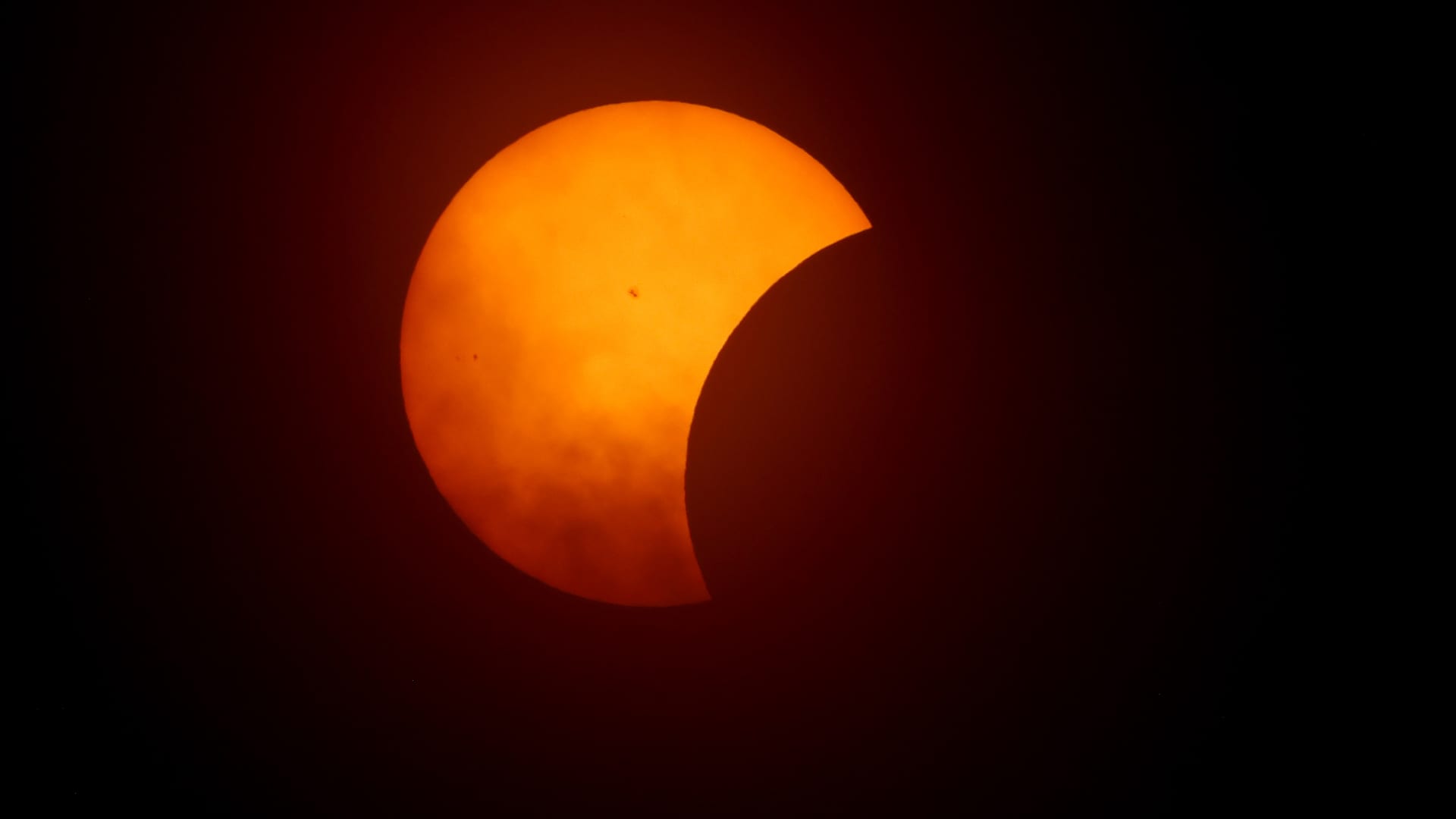 The moon begins to eclipse the sun on April 8, 2024 in Fort Worth, Texas. 