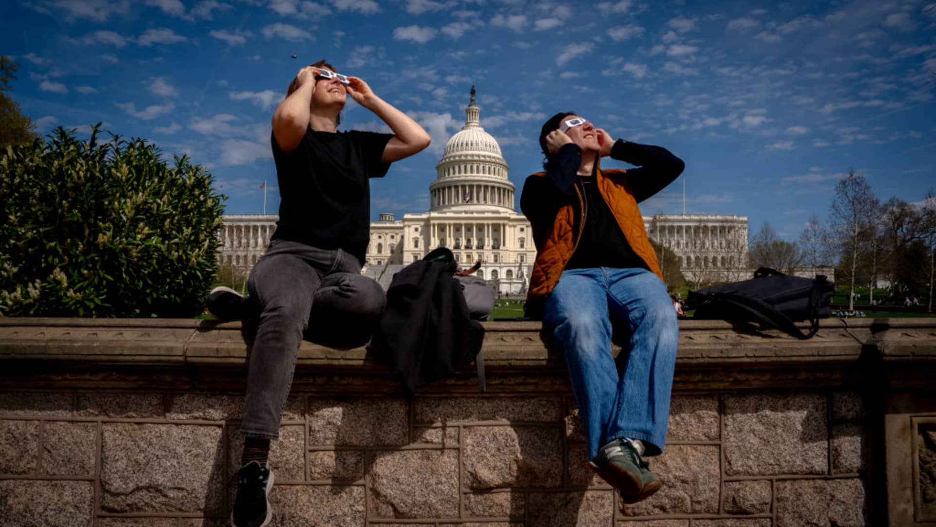 The U.S. Capitol Building is visible as people view the partial solar eclipse on Capitol Hill on April 8, 2024 in Washington, DC. 